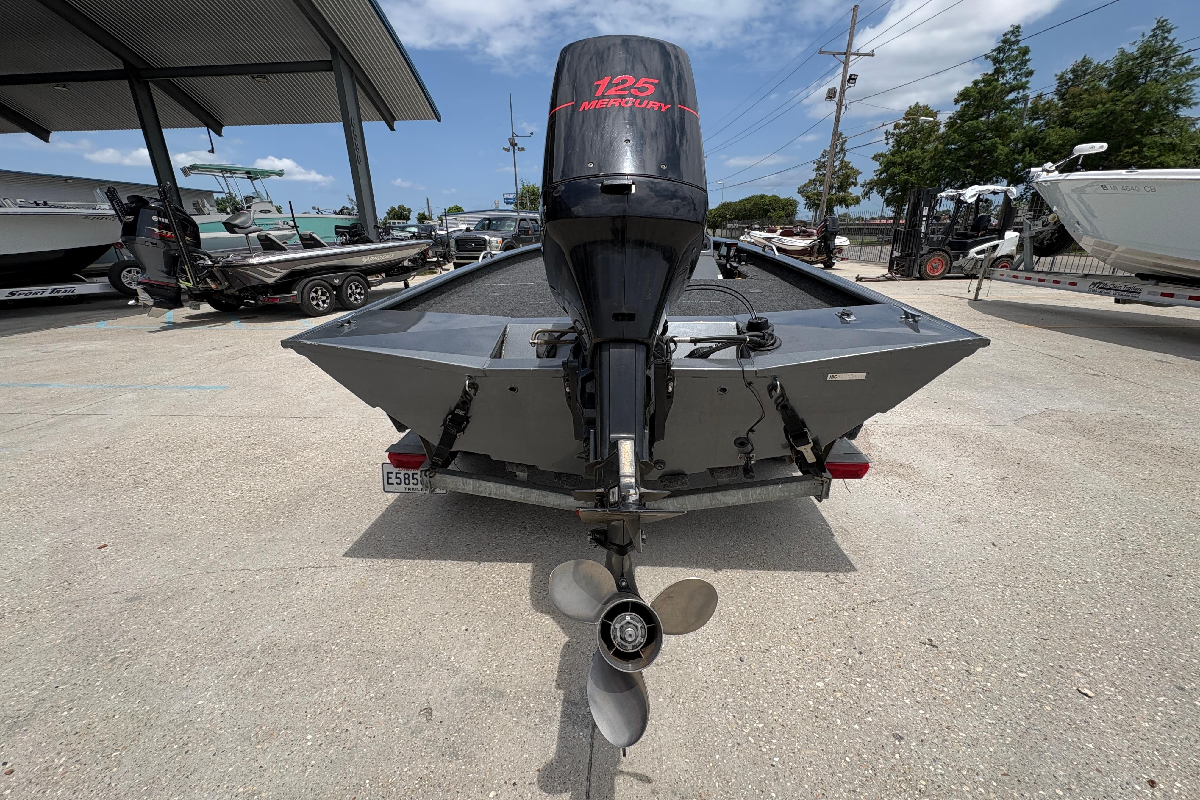 Rear view of 2000 Xpress X18 boat with Mercury 125 outboard motor.