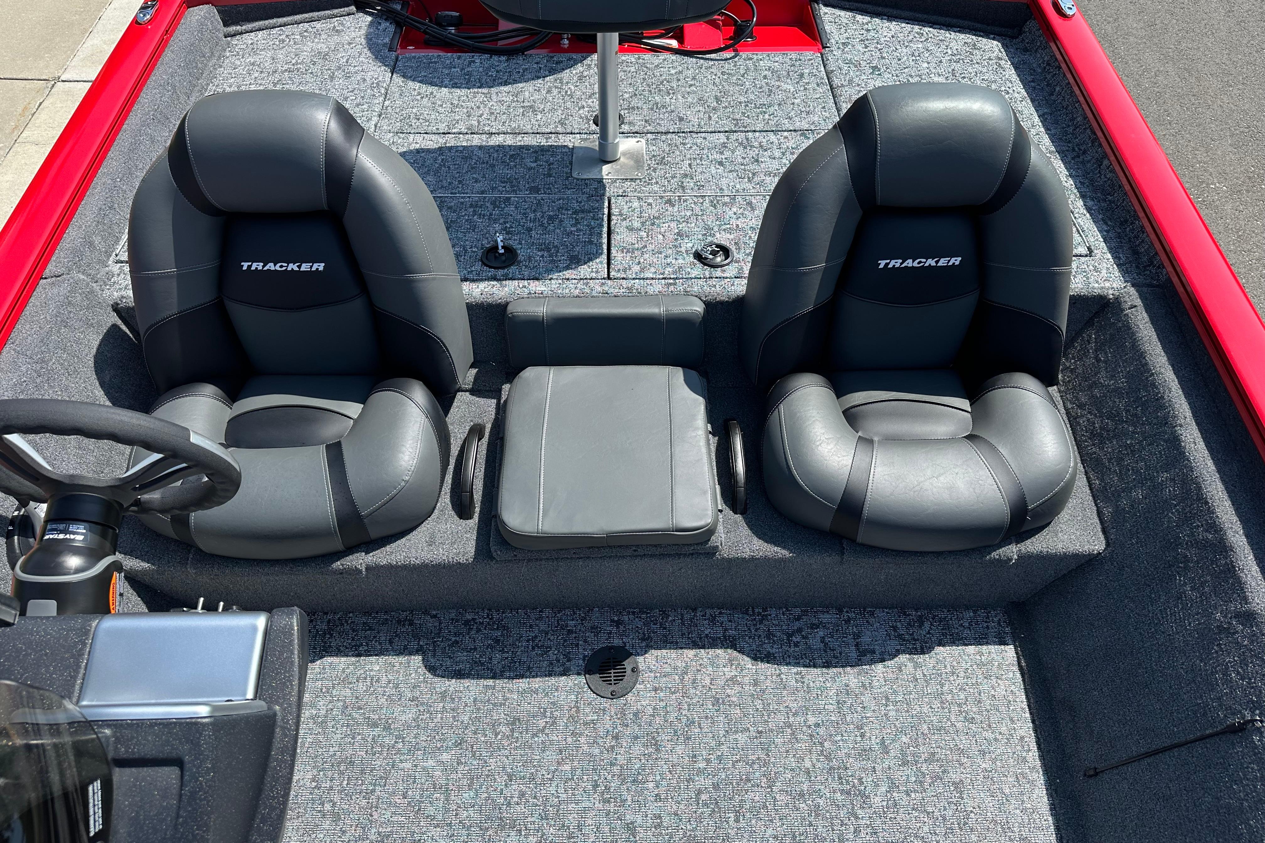 Interior of 2026 Tracker Pro Team 195 boat with dual black seats and steering wheel.