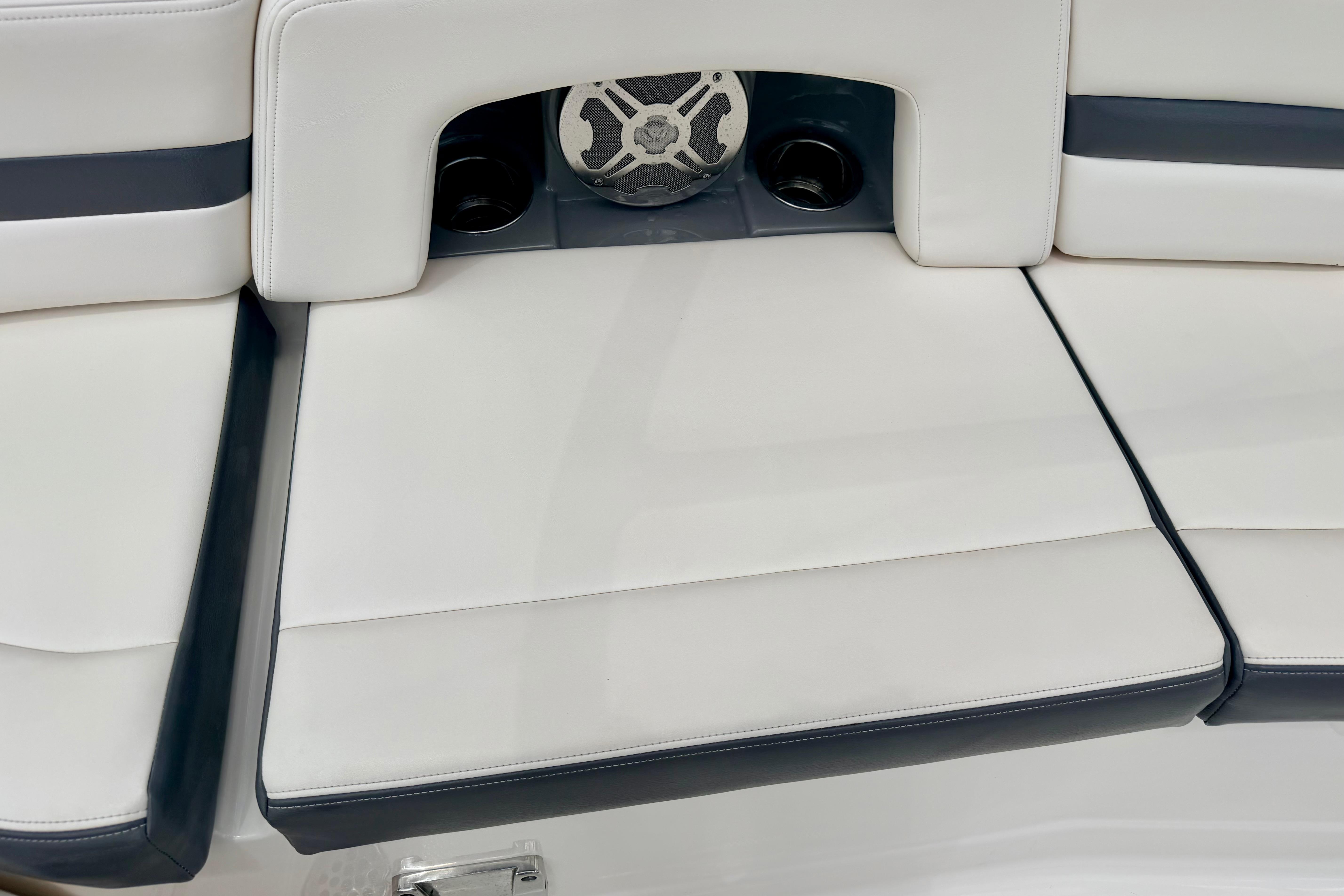 2015 Chaparral Sunesta 264 boat seating with integrated speaker and cup holders.