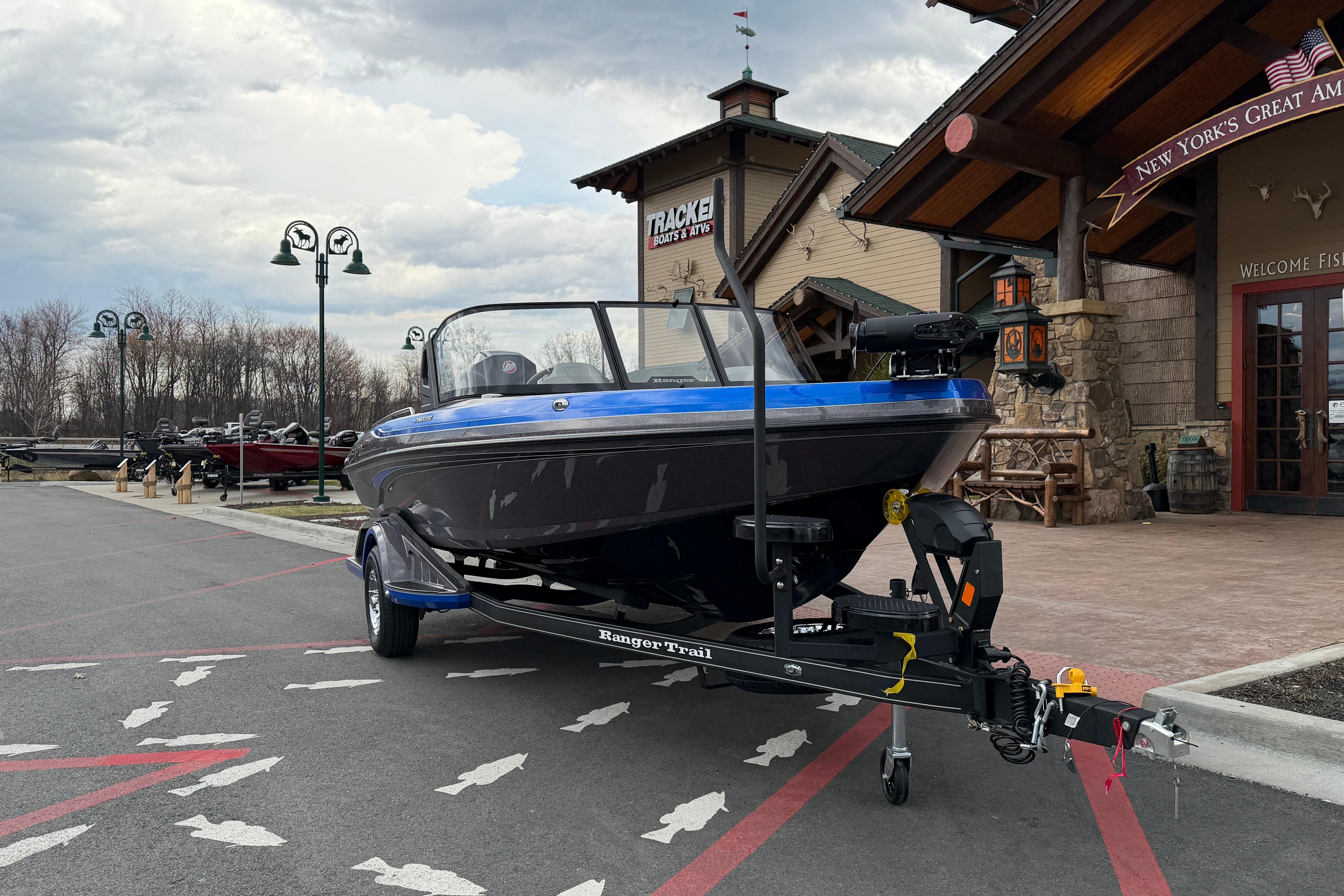 2026 Ranger 1880MS boat on trailer outside a rustic building under cloudy skies.