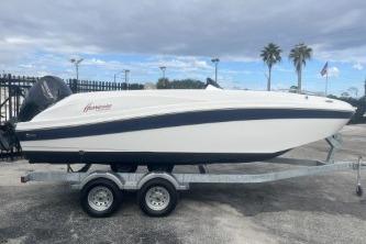 2021 Hurricane SunDeck Sport 192 RL OB boat on trailer, parked outdoors.