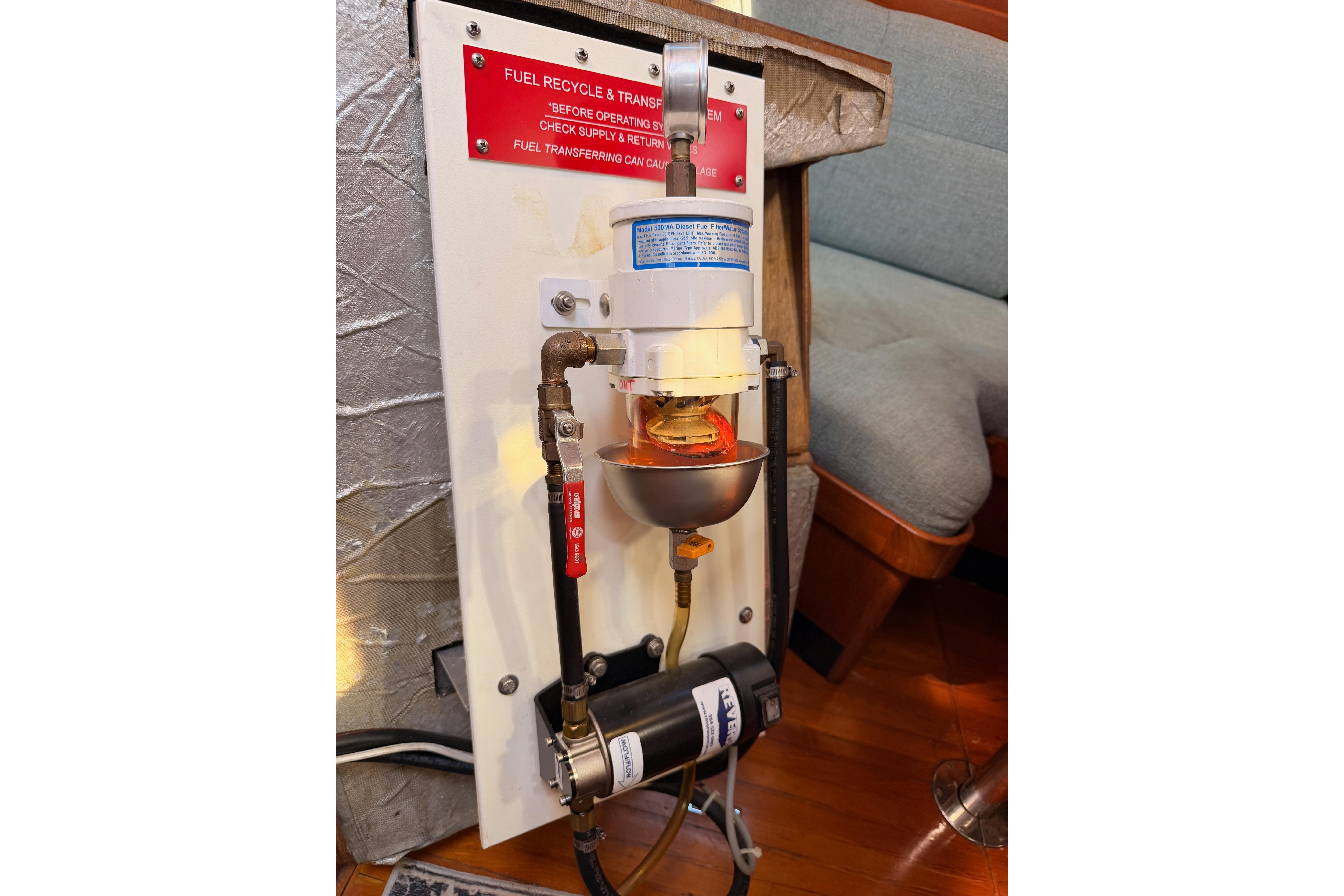 Fuel recycling system in a 1991 Hylas 51 yacht, featuring a filter and pump setup.