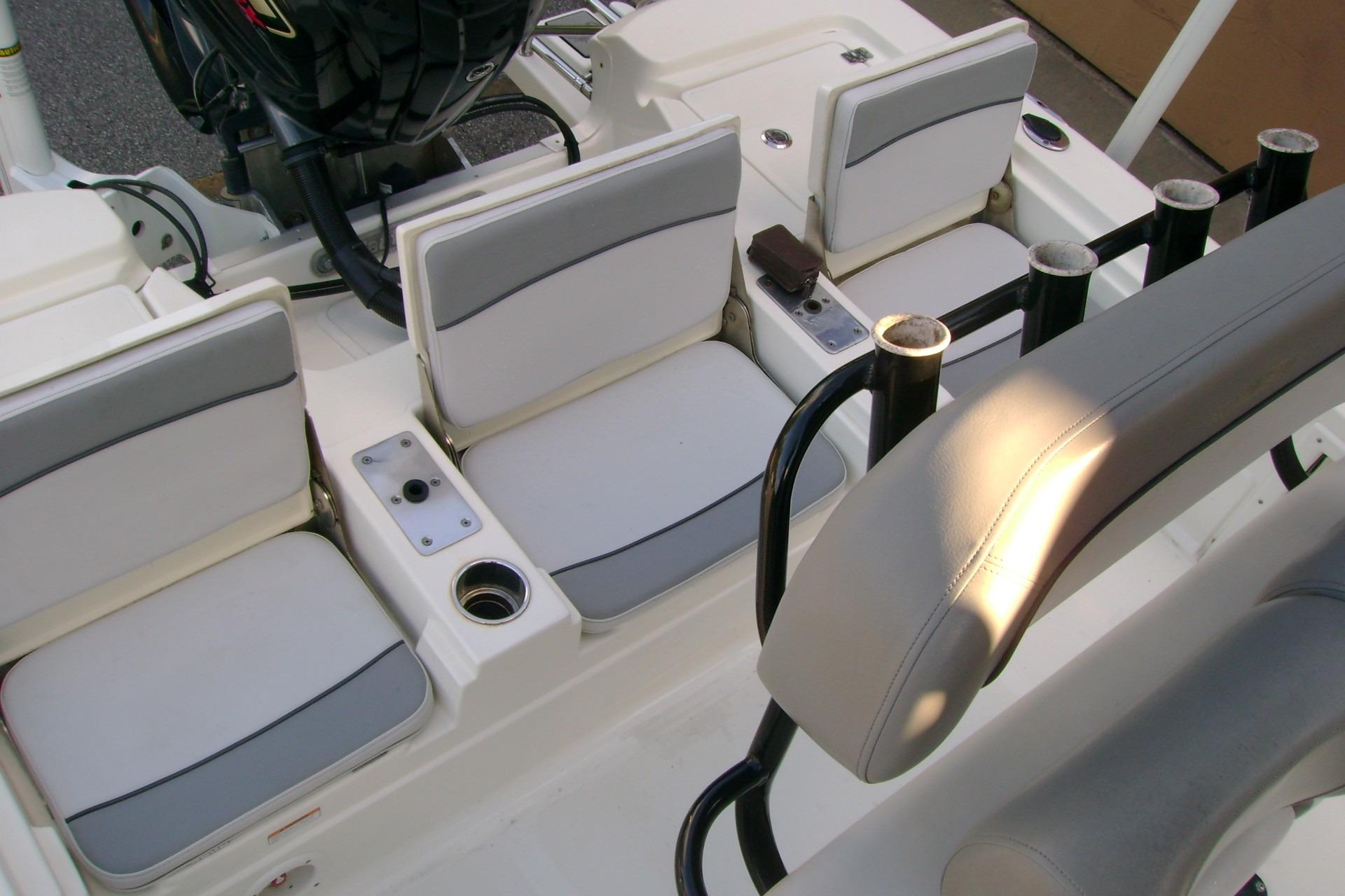 2022 NauticStar 227 XTS boat interior with cushioned seating and rod holders.