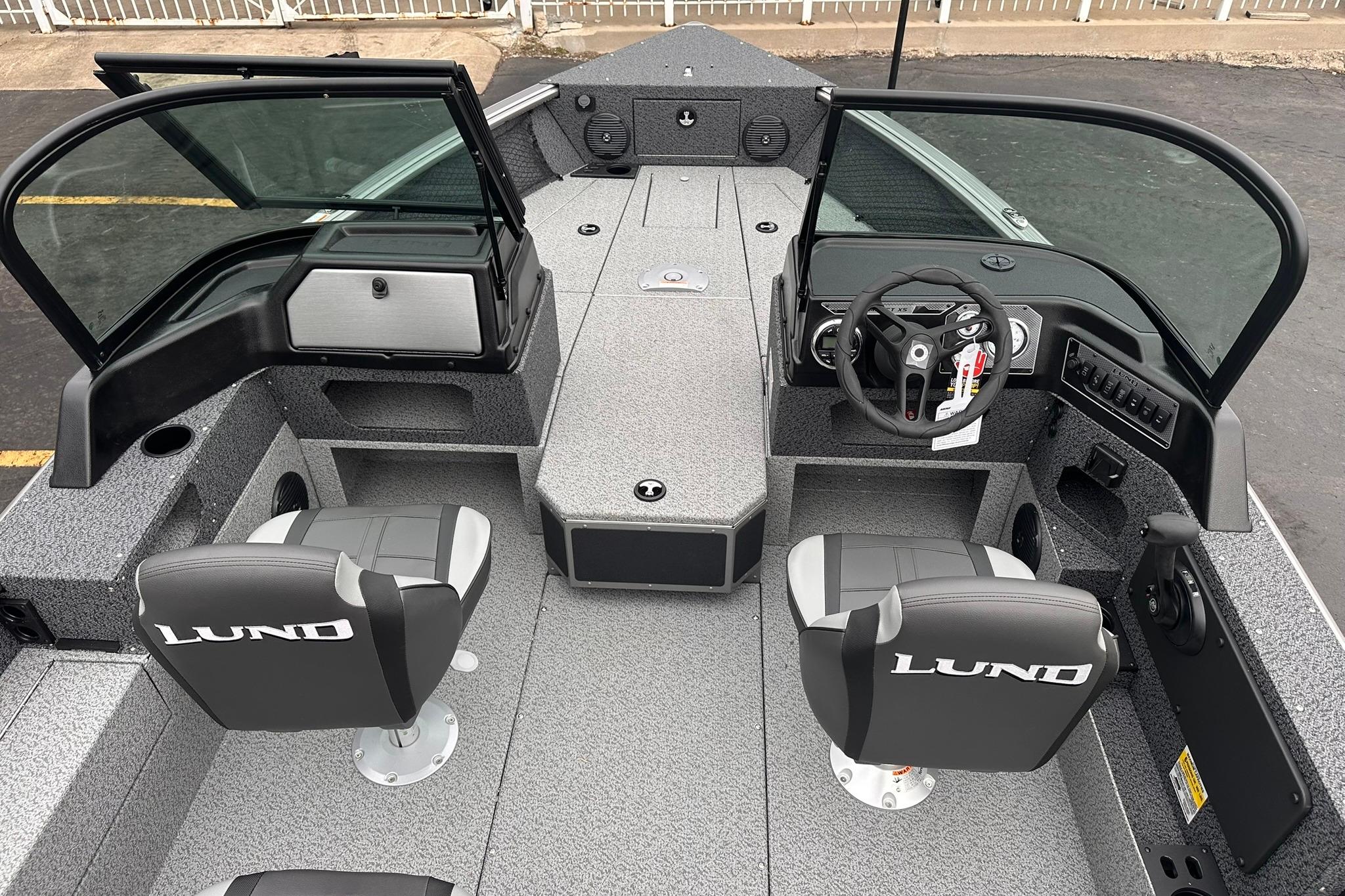 2026 Lund 1775 Impact XS Sport boat interior with dual seats and steering console.
