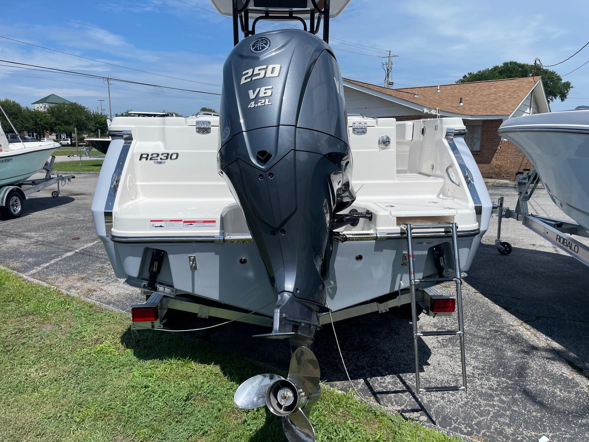 2025 Robalo R230 Center Console boat with Yamaha 250 V6 engine, parked outdoors.