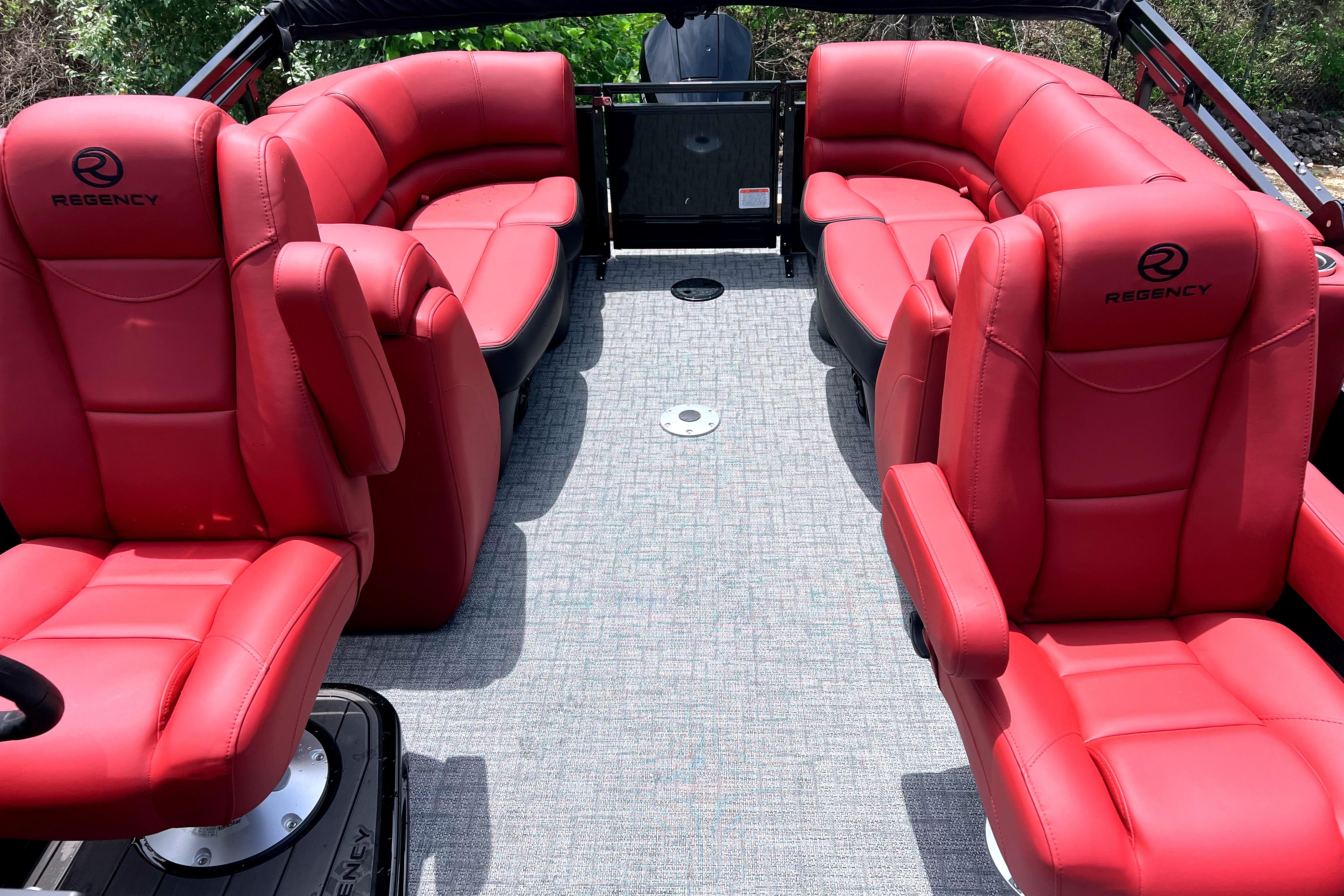 Luxurious 2026 Regency 230 DL boat interior with red leather seating and modern design.