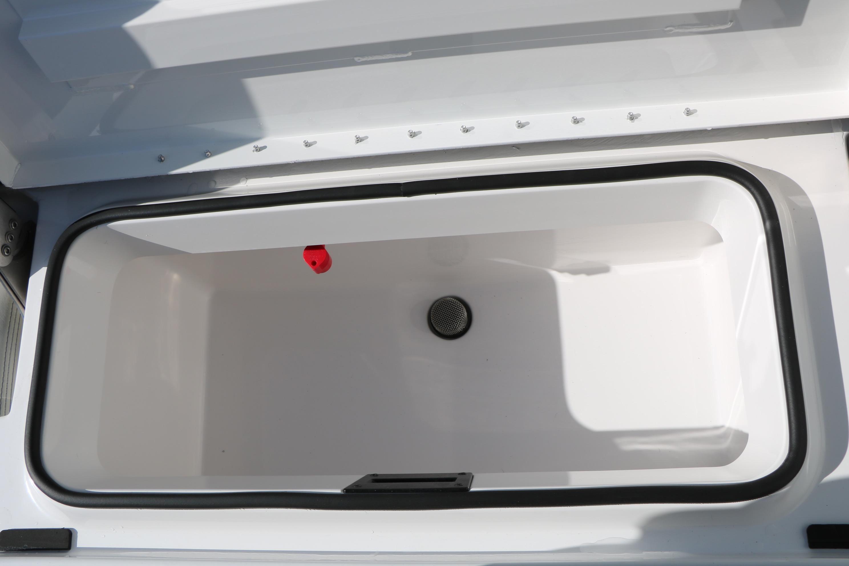 Open storage compartment of 2026 Vexus ACX2000 boat, featuring a sleek white interior.