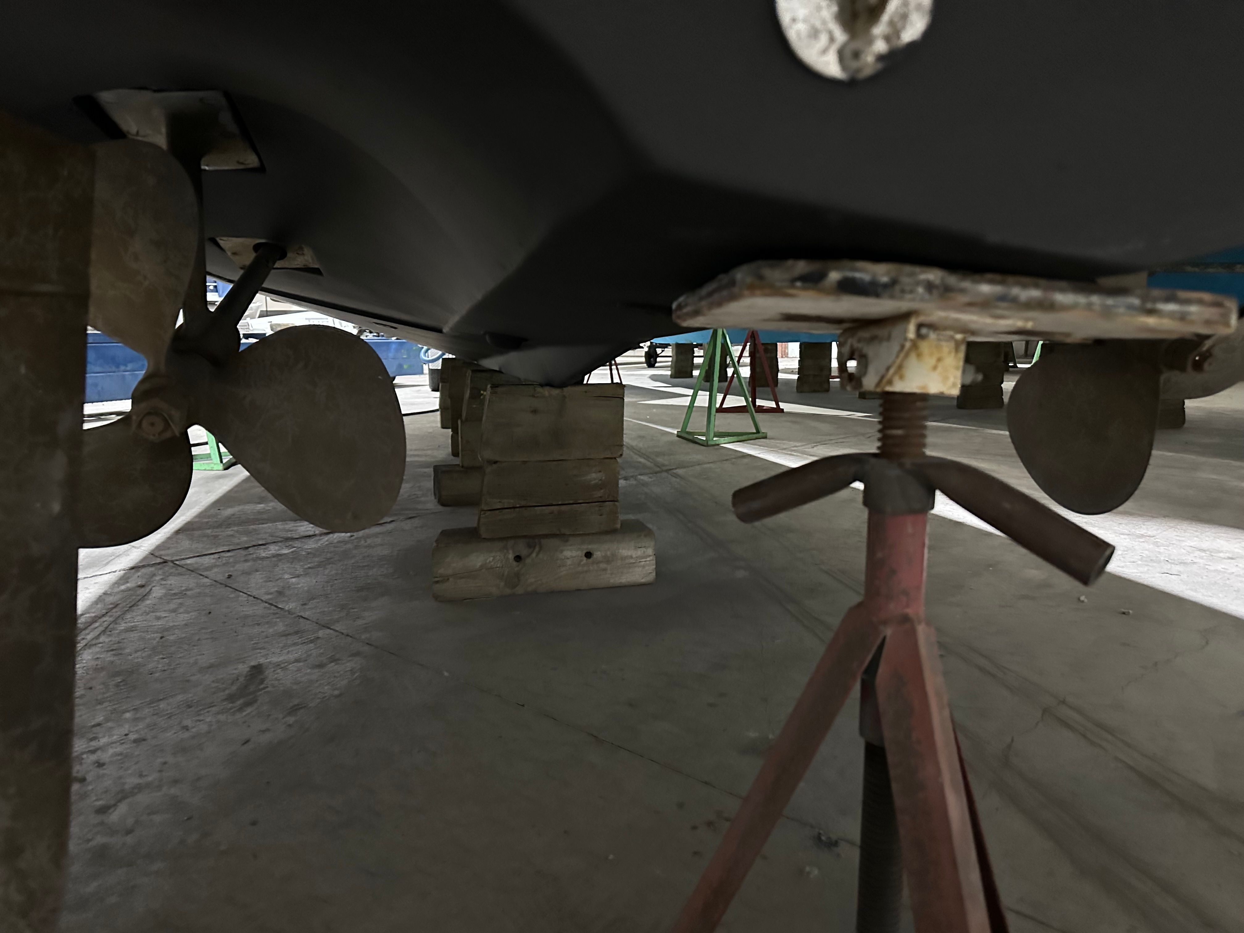 Underside of a 2000 Silverton 351 Sedan with supports and propeller.