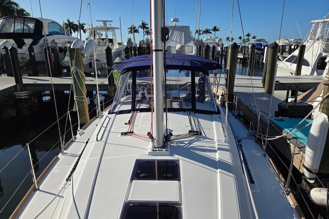 2023 Beneteau Oceanis 38.1 sailboat docked at marina, clear blue sky.