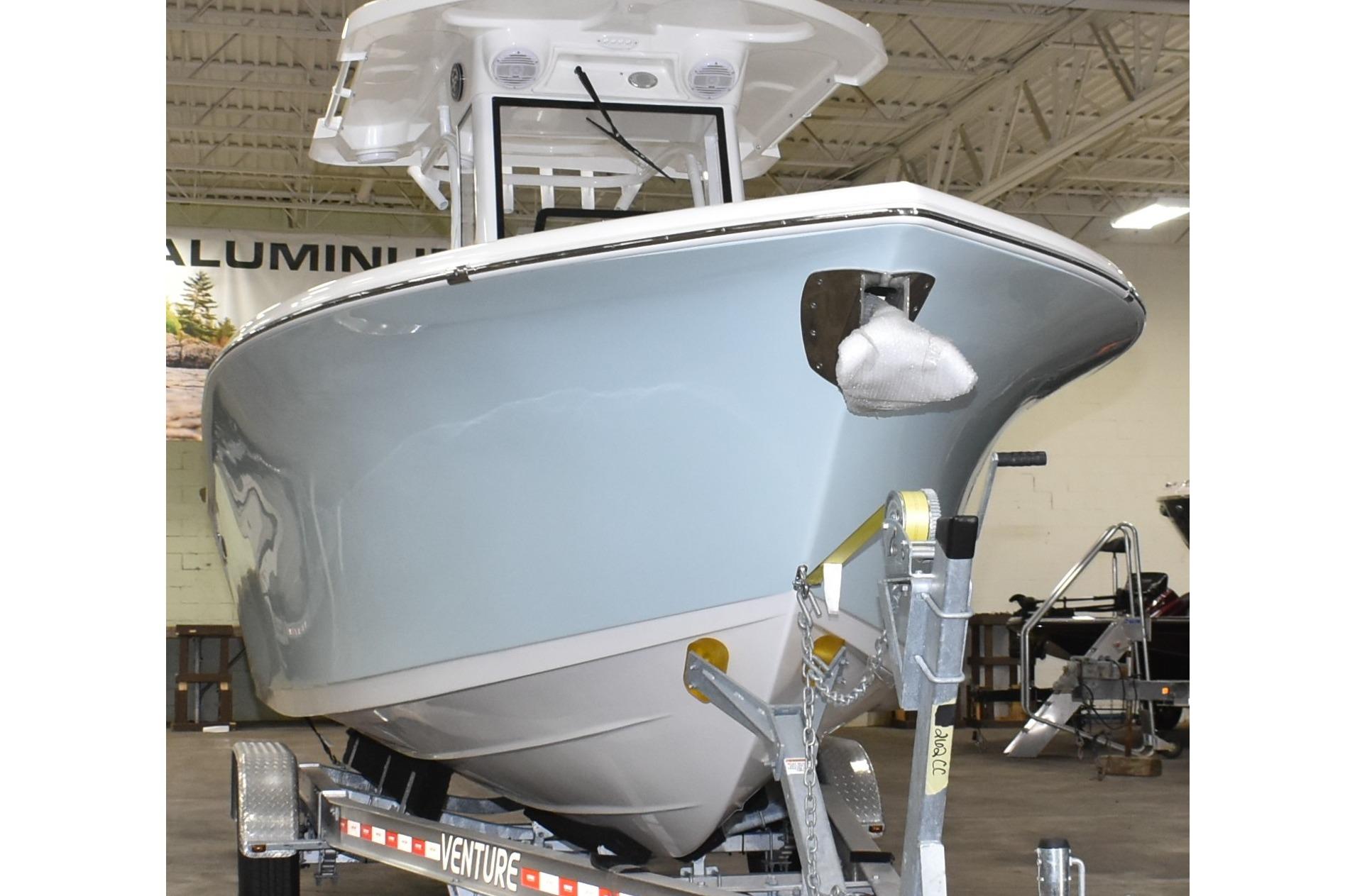 2025 Sea Pro 262 Offshore boat on trailer in indoor showroom.