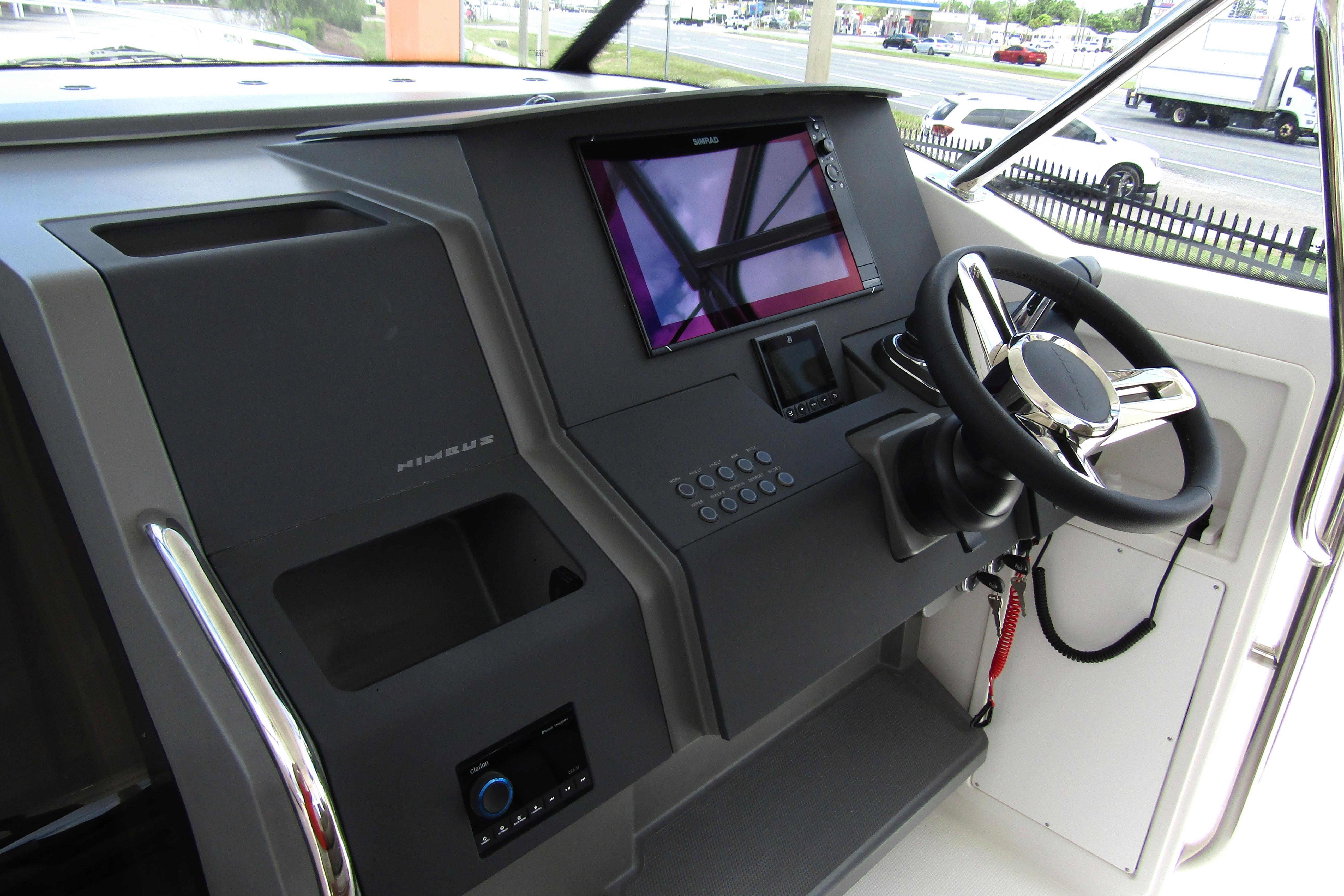 Helm of 2025 Nimbus Tender 11 with modern controls and steering wheel.