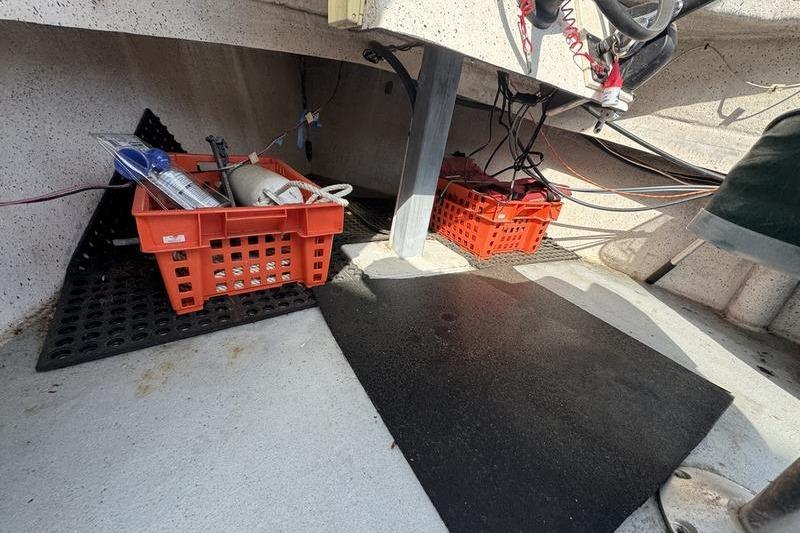 Interior of 2001 ROS Boats 19 RUNABOUT with storage crates and equipment.