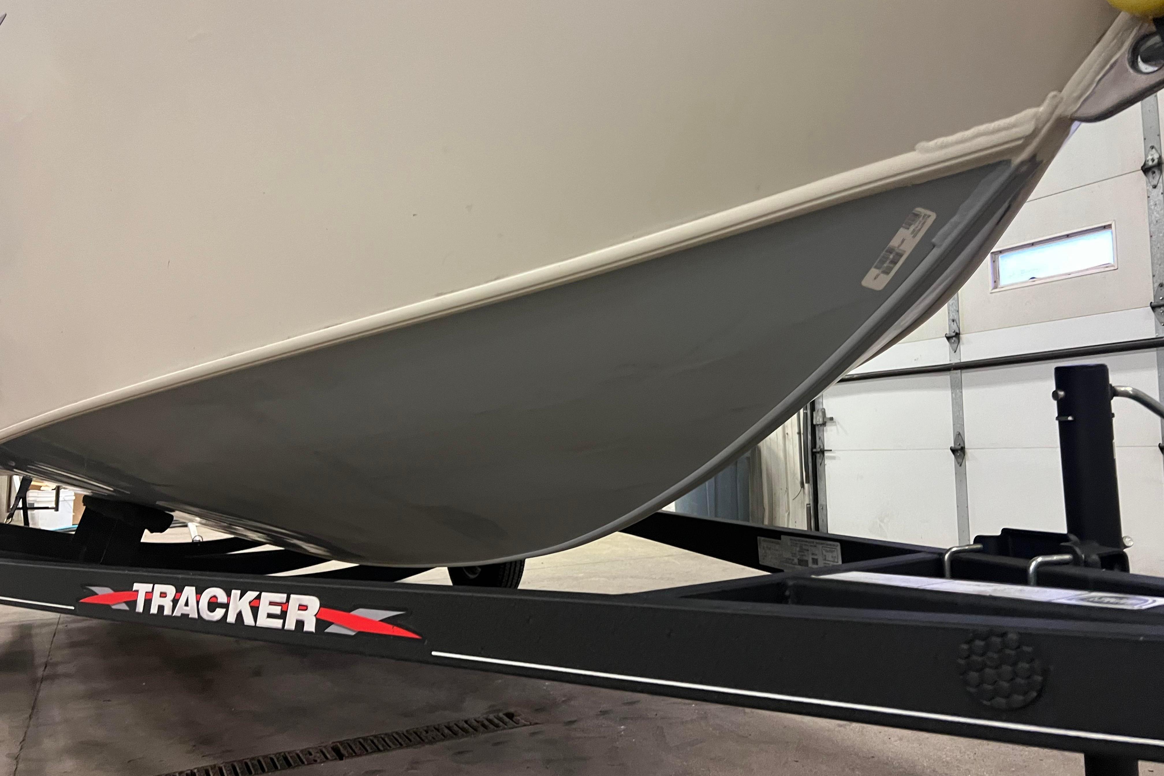 2022 Tracker Pro Guide V-16 WT boat on trailer in garage.