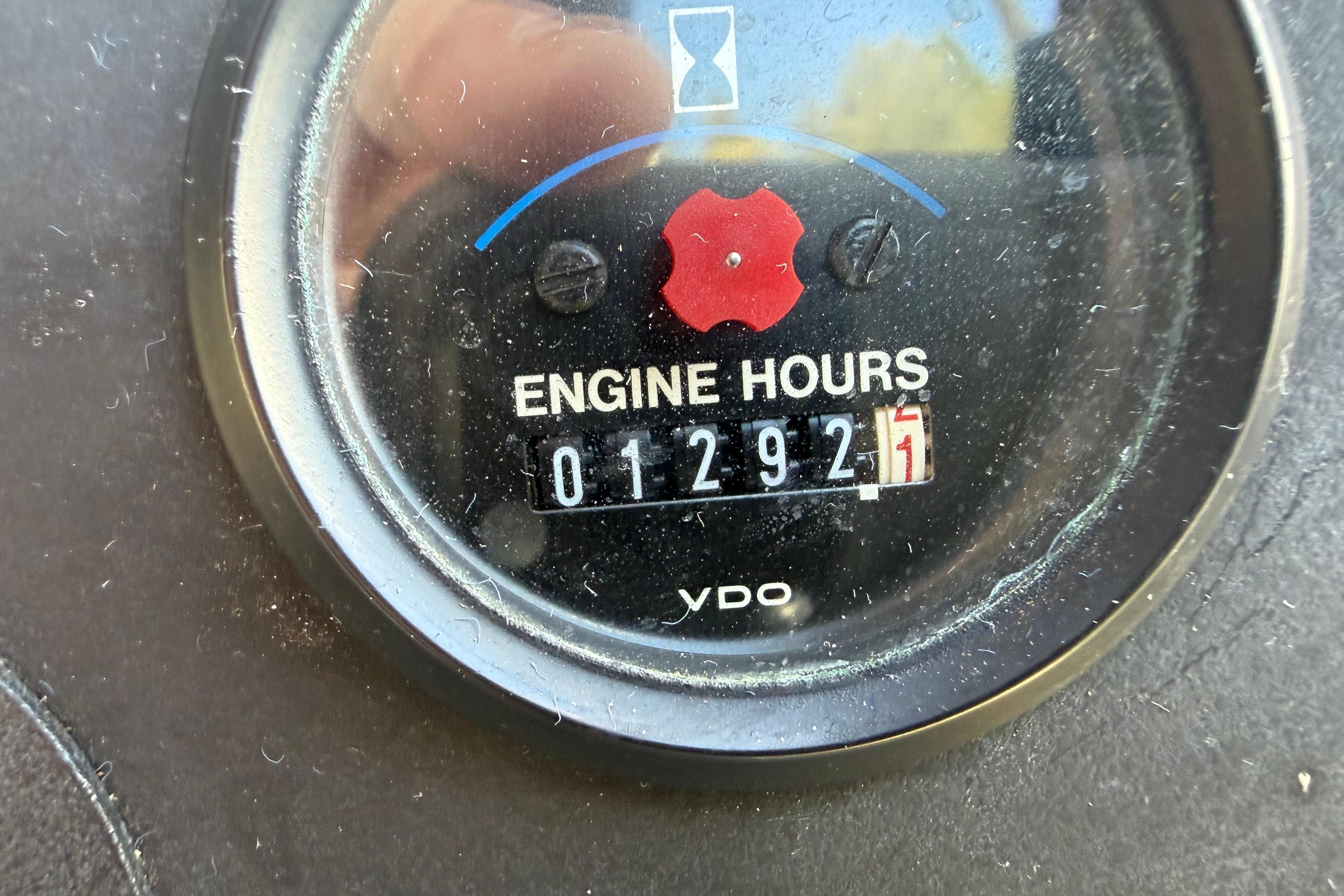 Close-up of Carver 370 Voyager 1995 engine hour meter showing 1292.1 hours.