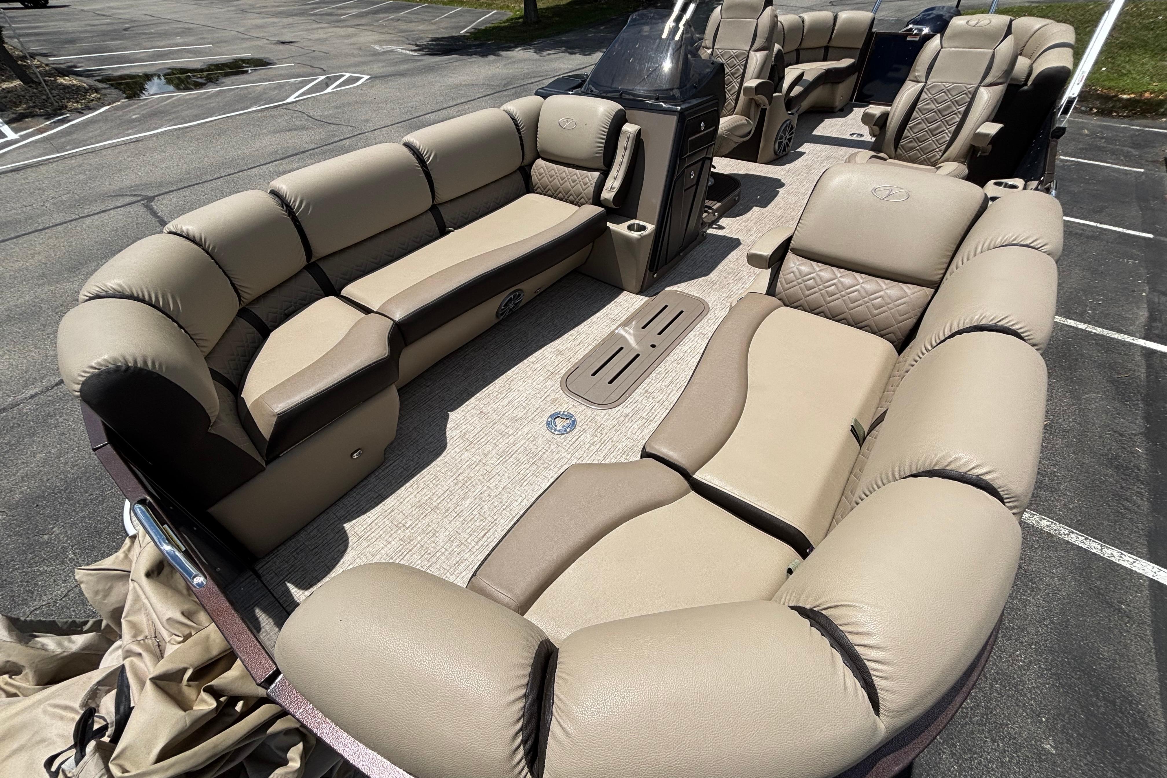 Luxurious 2021 Veranda VP25RC pontoon boat with plush beige seating and spacious layout.