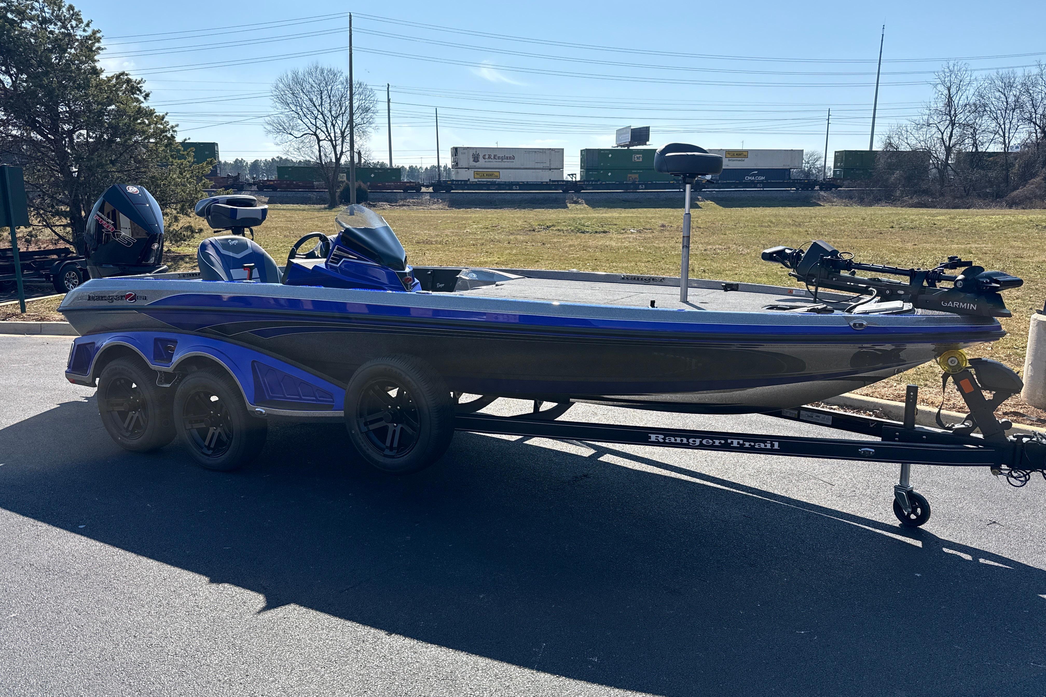 2026 Ranger Z521 boat on trailer, parked outdoors, with blue and gray design.