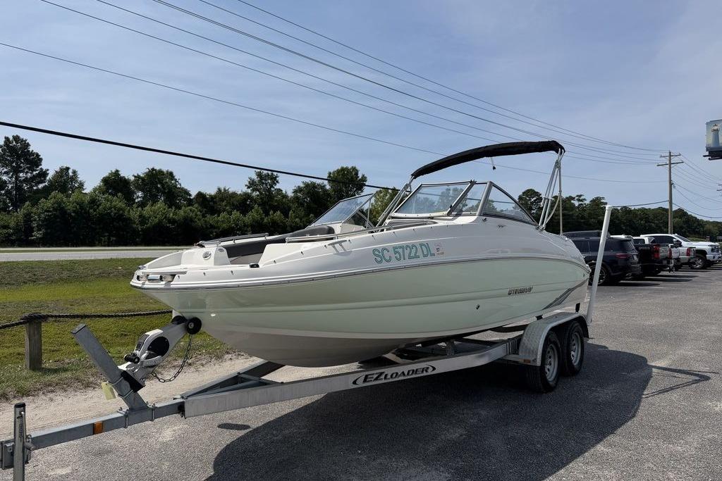 2019 Stingray 201 DS boat on trailer, parked outdoors under clear sky.