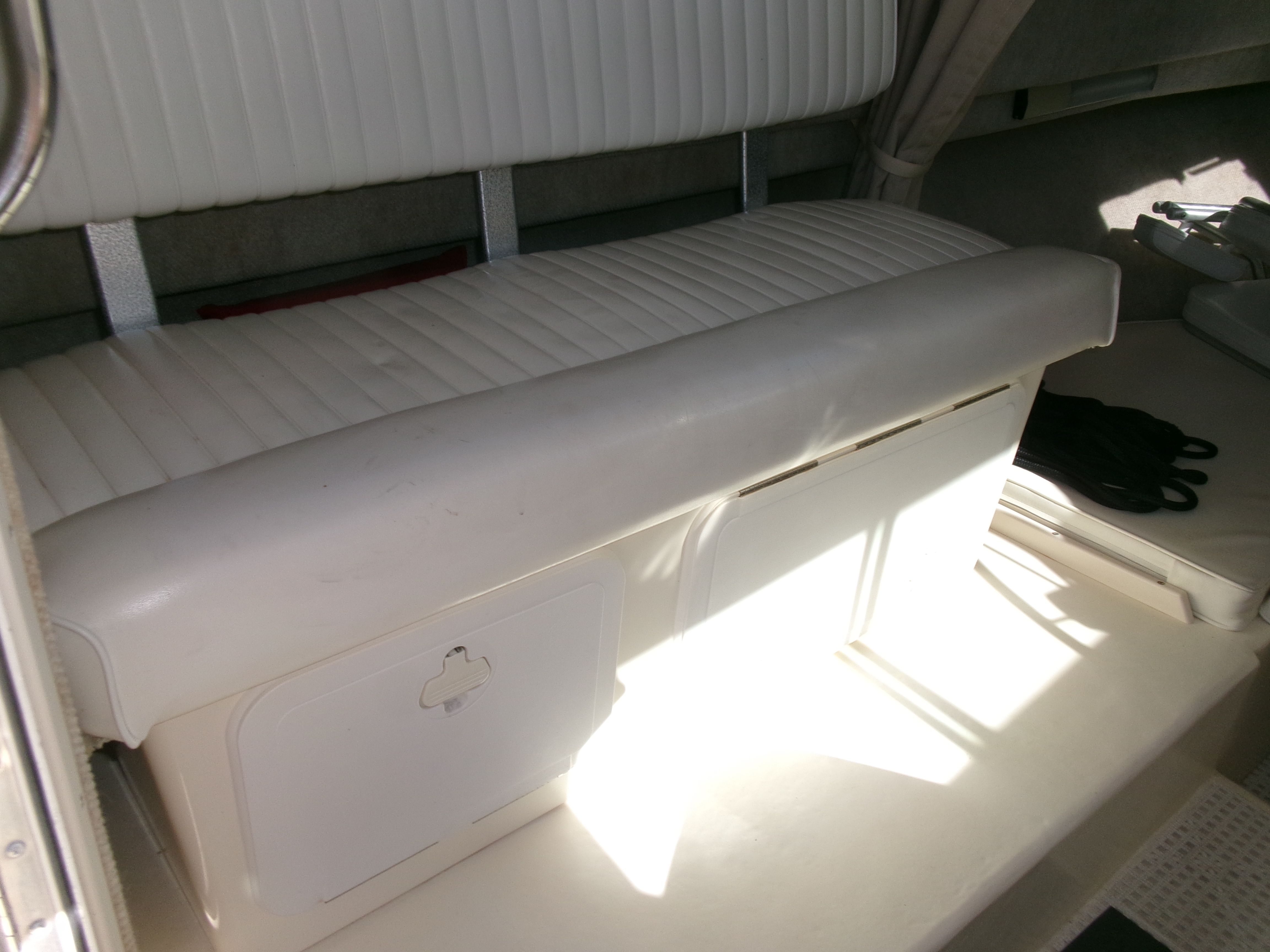 Interior of a 2007 Parker 2520 XL Sport Cabin with white upholstered bench and storage.