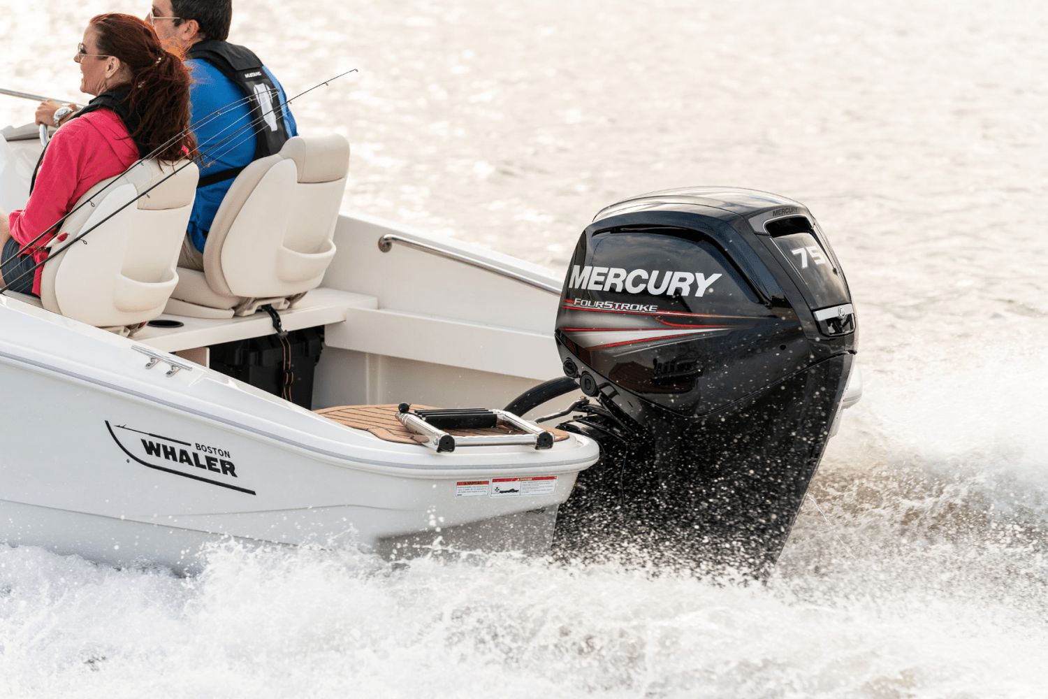 Two people ride in a Boston Whaler 160 Super Sport with a Mercury engine on the water.