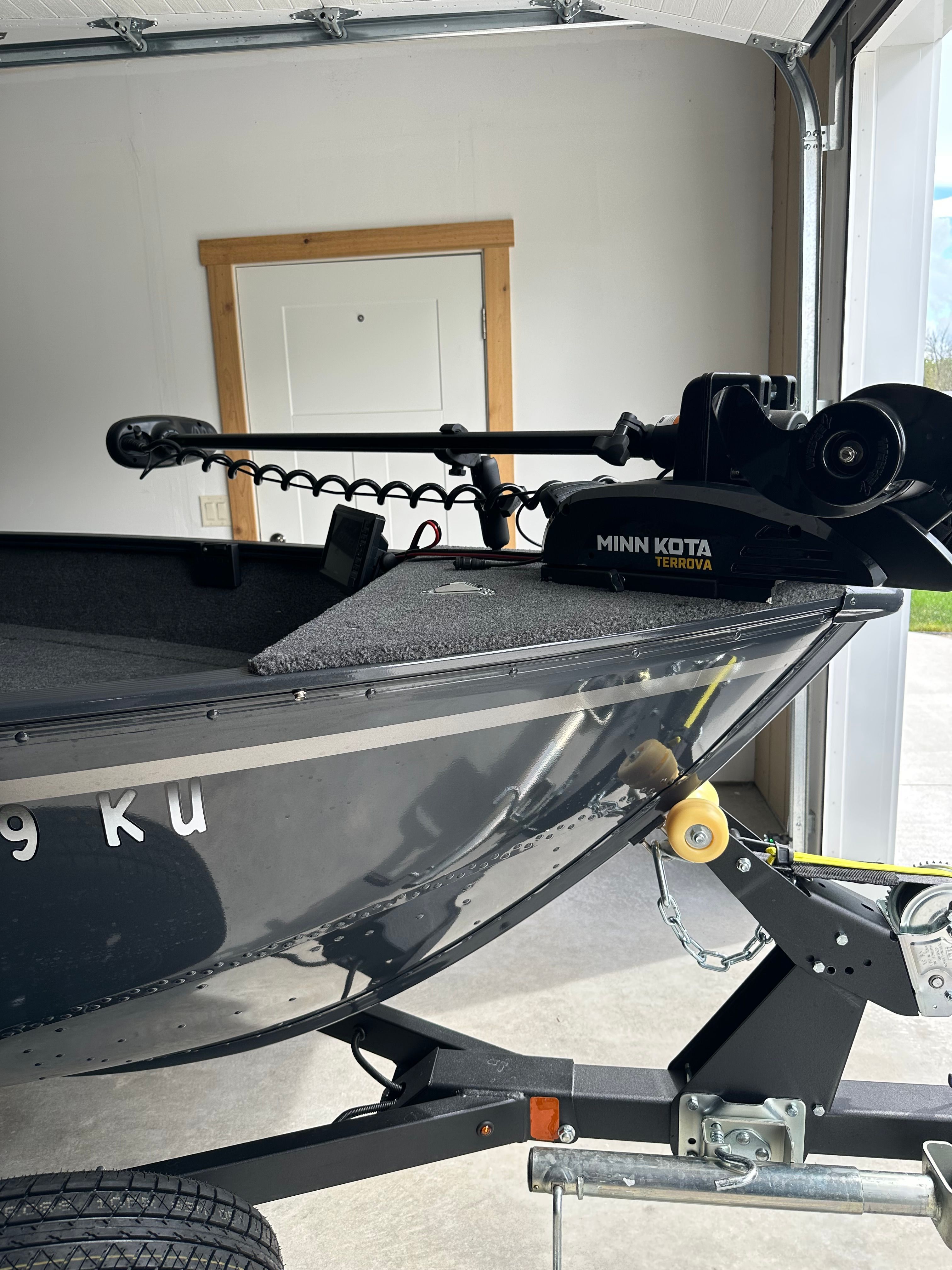 A 2025 Lund Pro Angler 1650 with a Minn Kota Terrova motor in a garage.