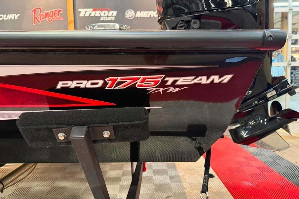 2024 Tracker Pro Team 175 boat displayed indoors with branding and logos.