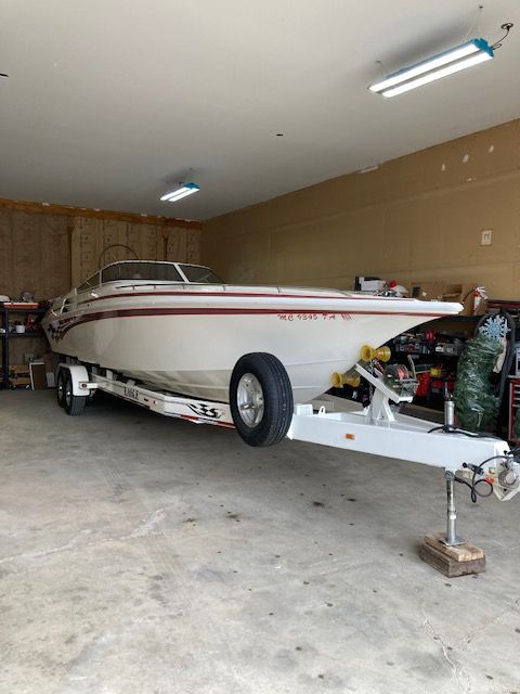 2001 Fountain Lightning boat in garage on trailer.
