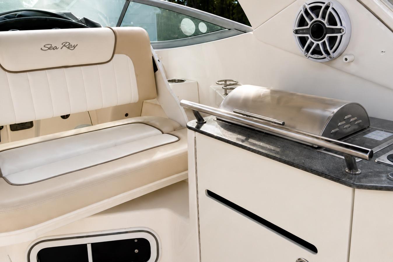 Luxurious interior of 2012 Sea Ray Sundancer 310 with seating and grill.