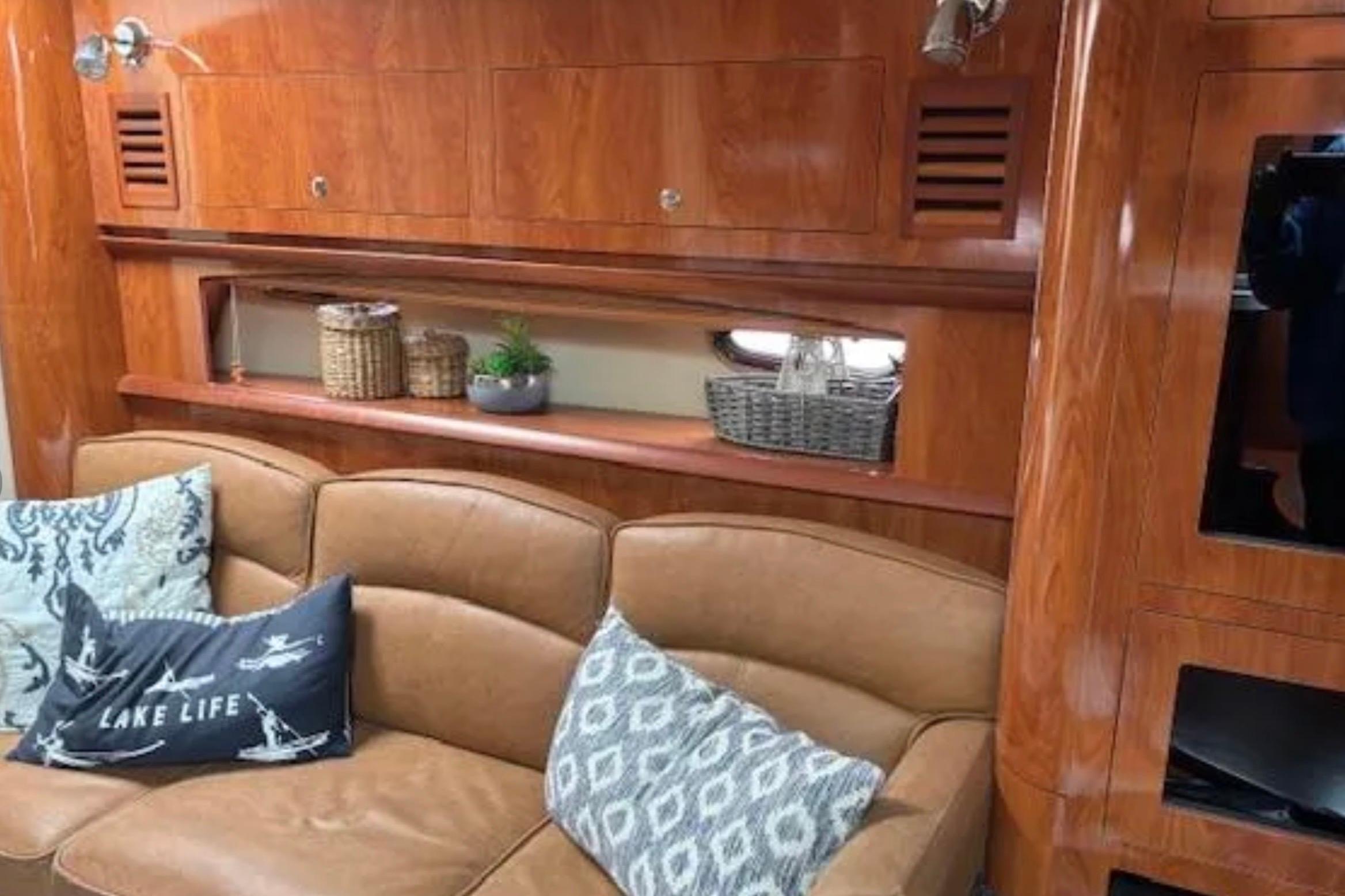 Luxurious 2007 Four Winns 378 Vista yacht interior with leather seating and wooden cabinetry.