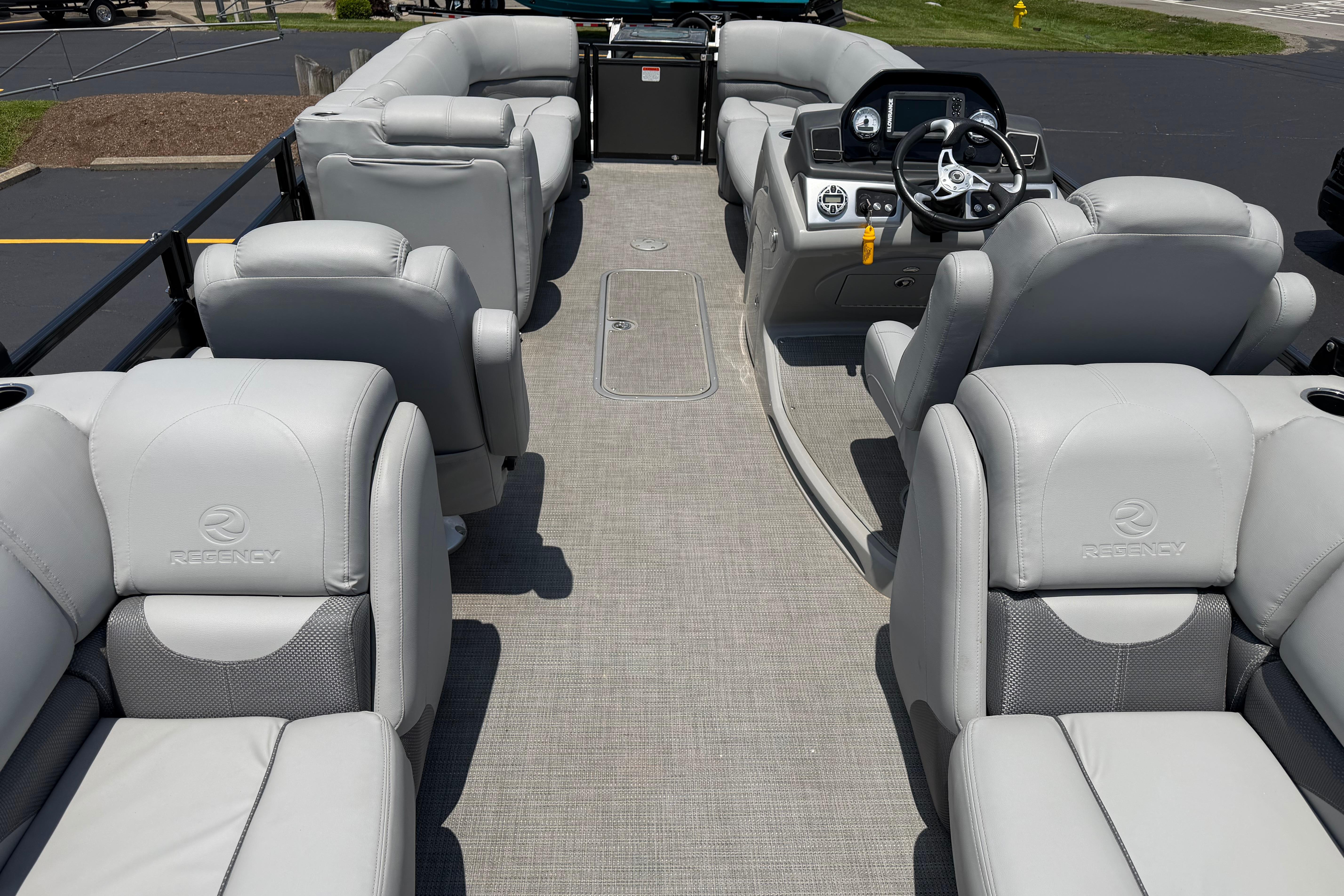 2019 Regency 230 DL3 pontoon boat interior with plush seating and modern dashboard.