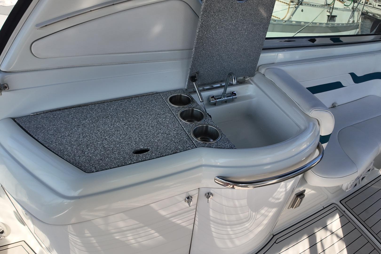 2007 Formula 330 Sun Sport boat interior with sink and cup holders.