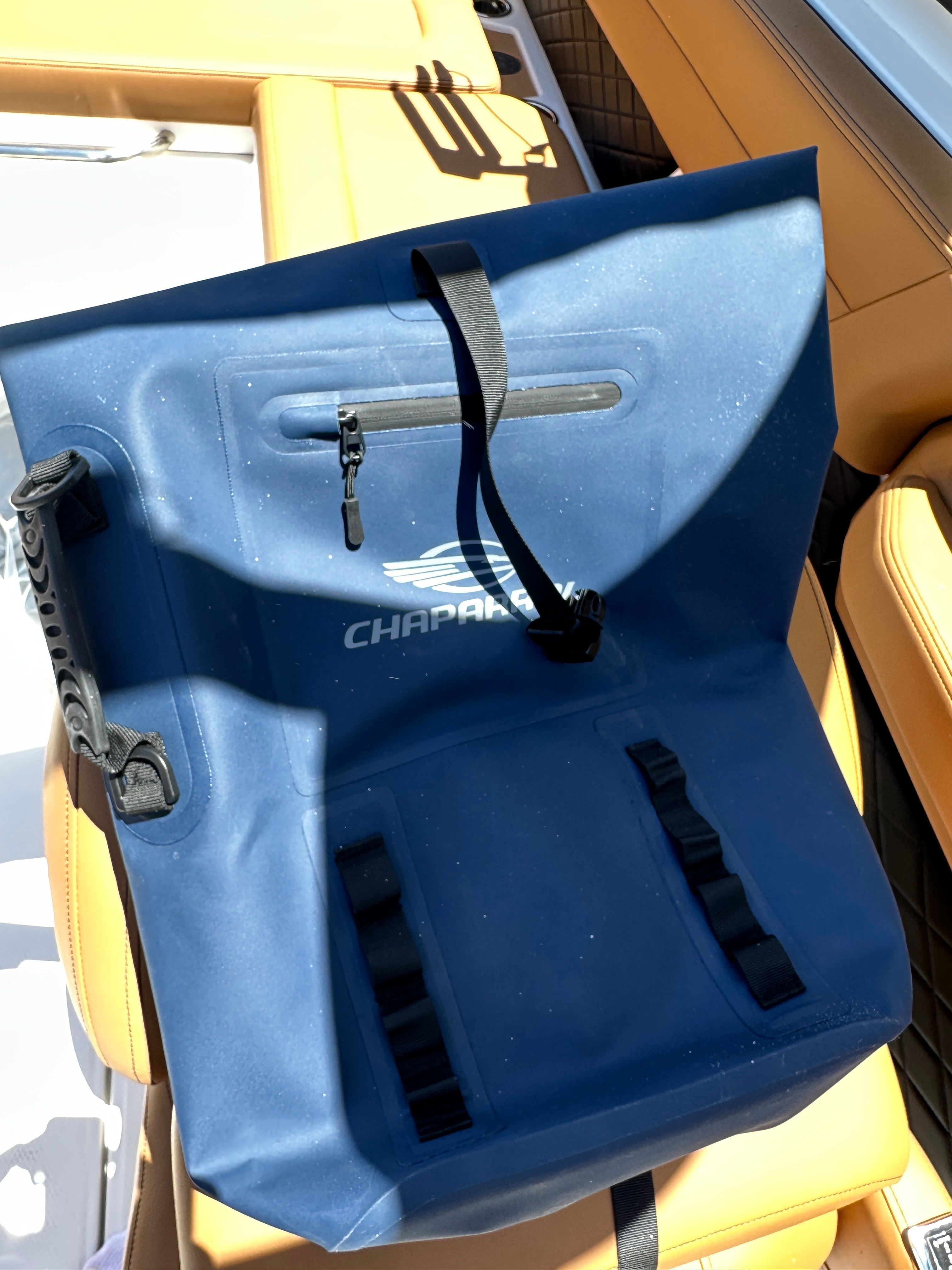 A blue bag with Chaparral logo rests on a boat seat.