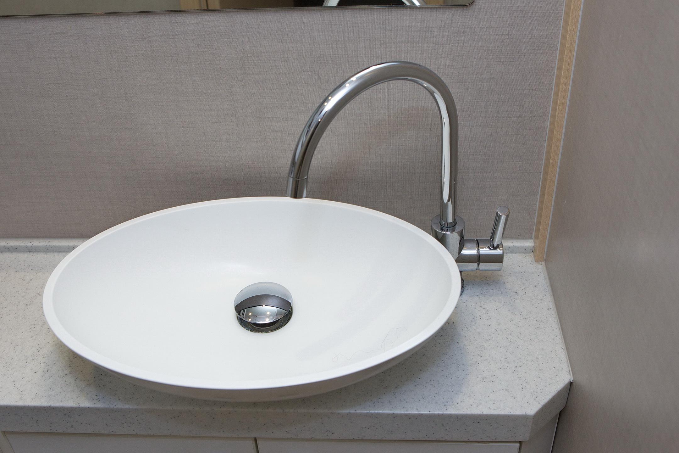 Modern white sink with chrome faucet on Greenline 48 Fly yacht, 2014 model.