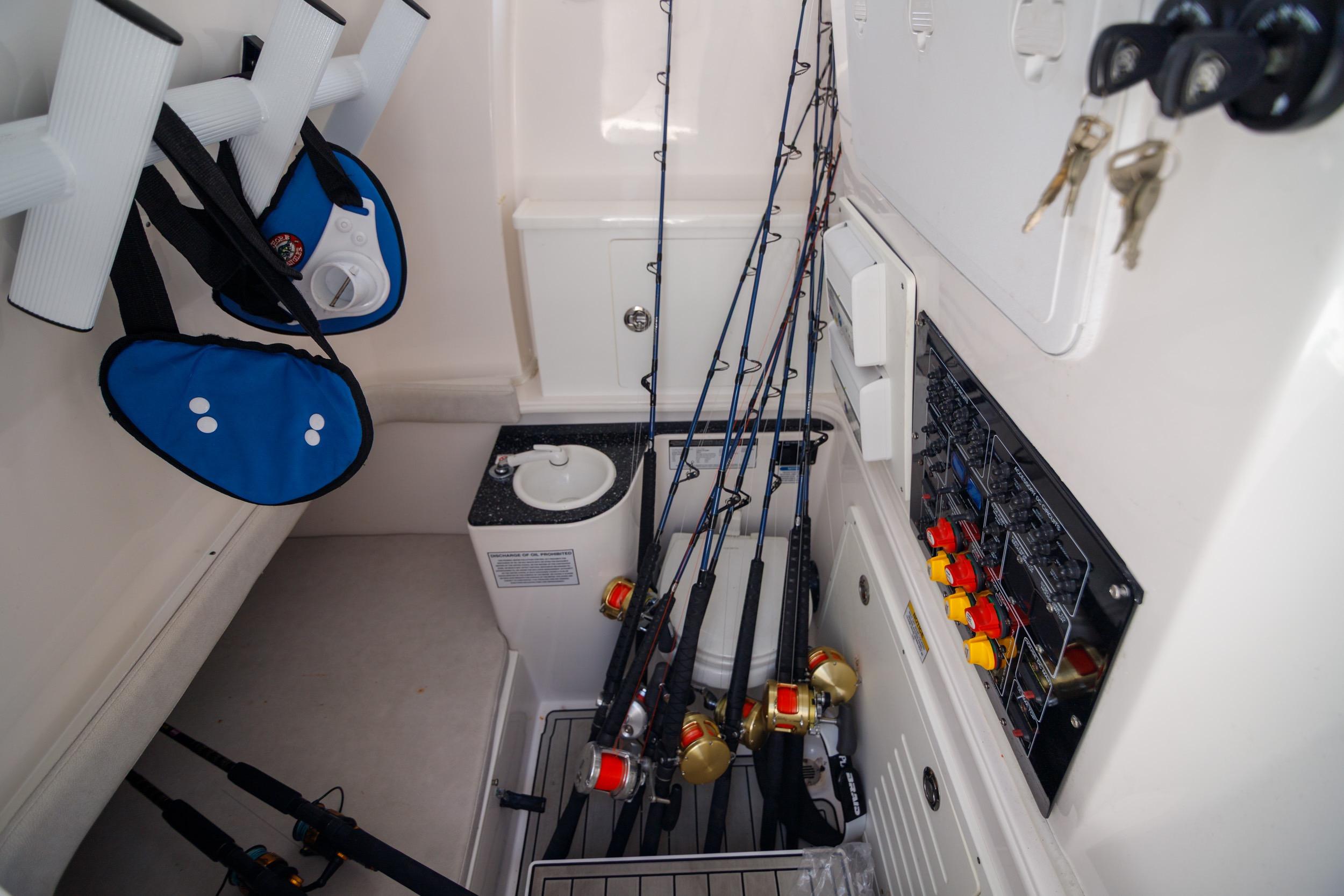 Interior of 2021 Sea Fox 328 Commander with fishing rods and equipment storage.
