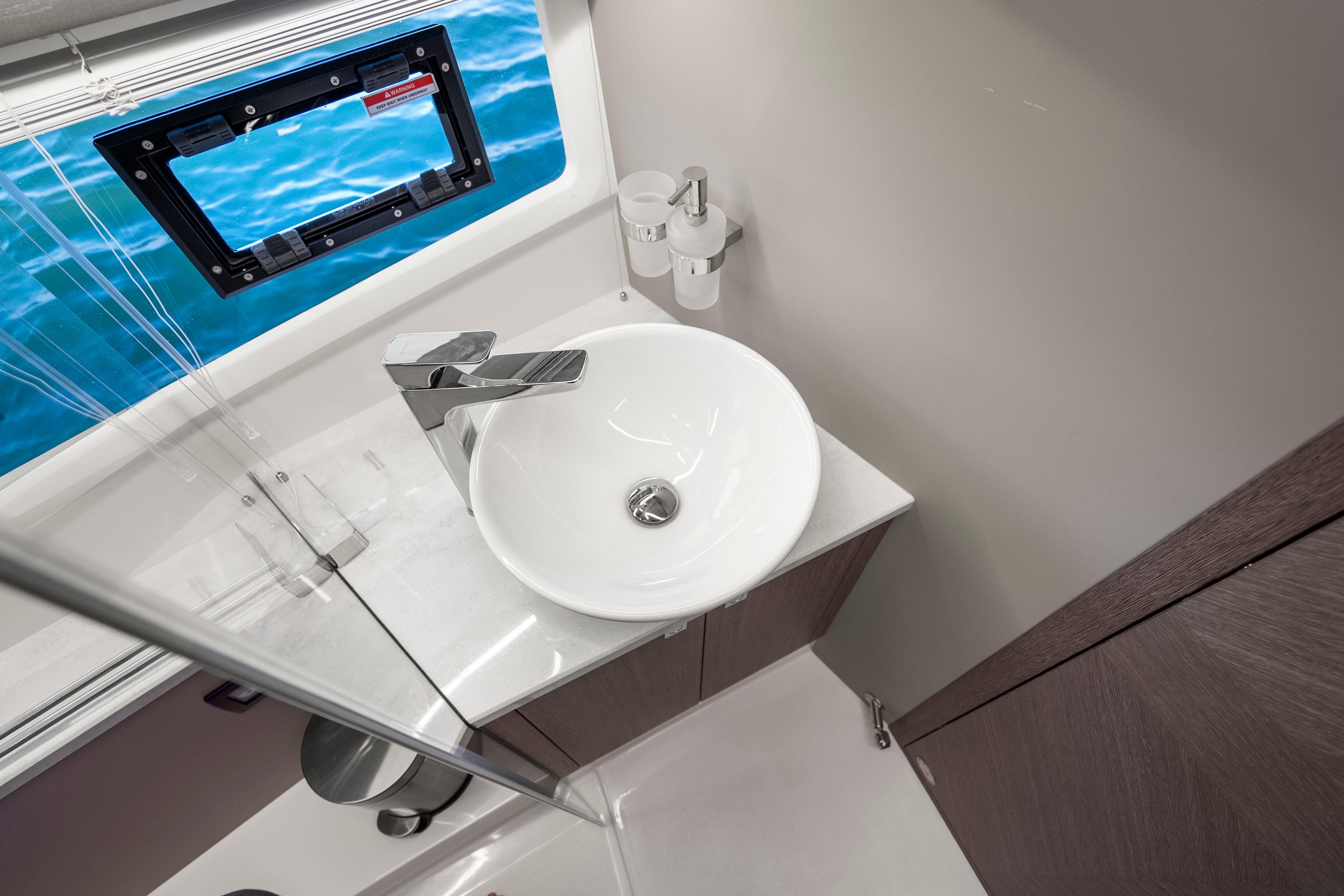 Modern bathroom interior on 2023 Galeon 400 Fly yacht with ocean view window.