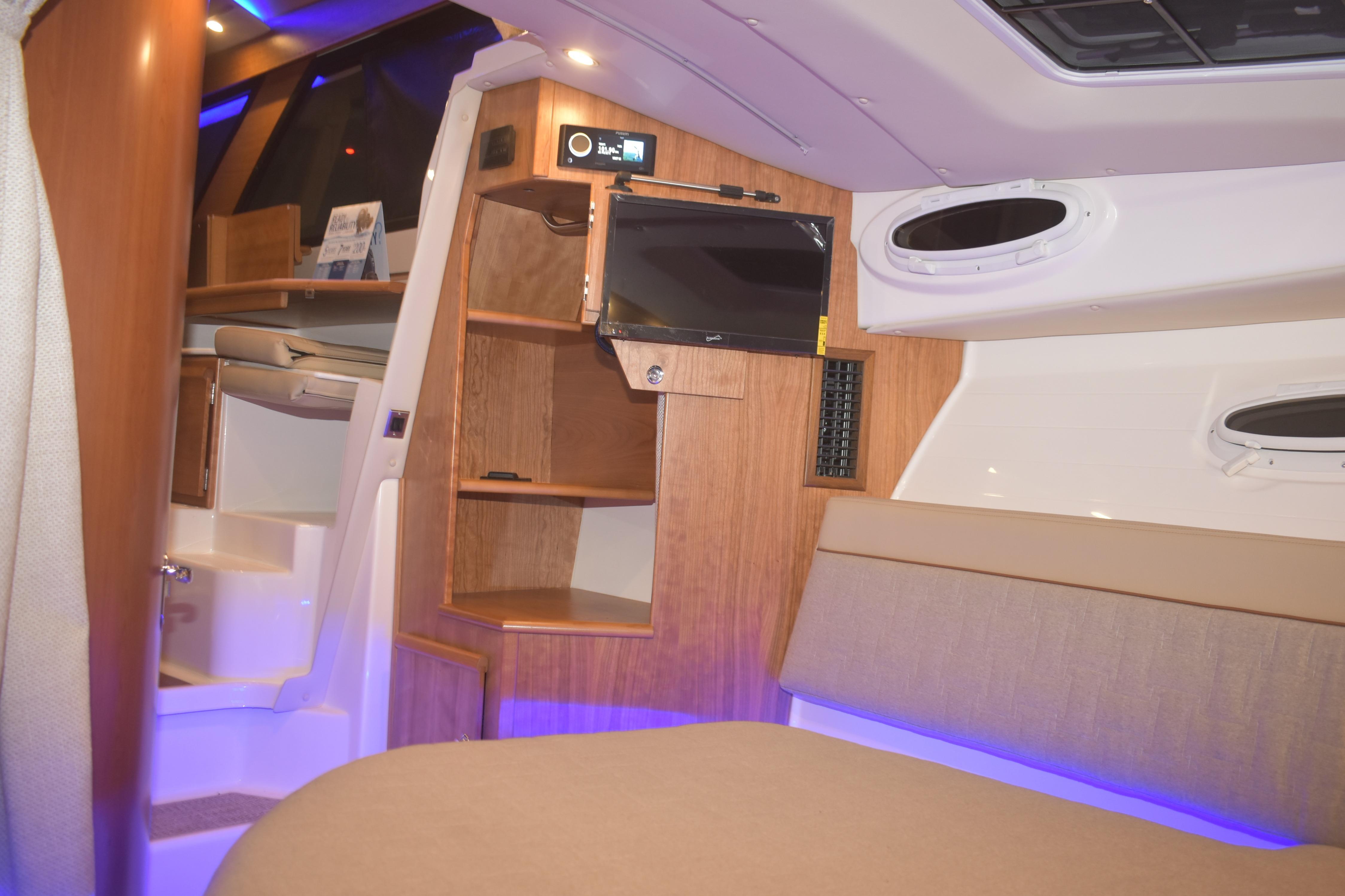 Interior of 2026 Cutwater C-32 CB boat with modern wood finish and ambient lighting.