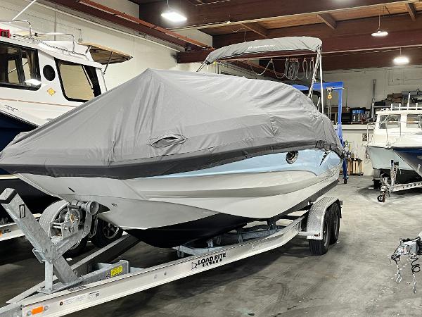 2023 Crownline Eclipse E235 XS boat covered on trailer in indoor storage.