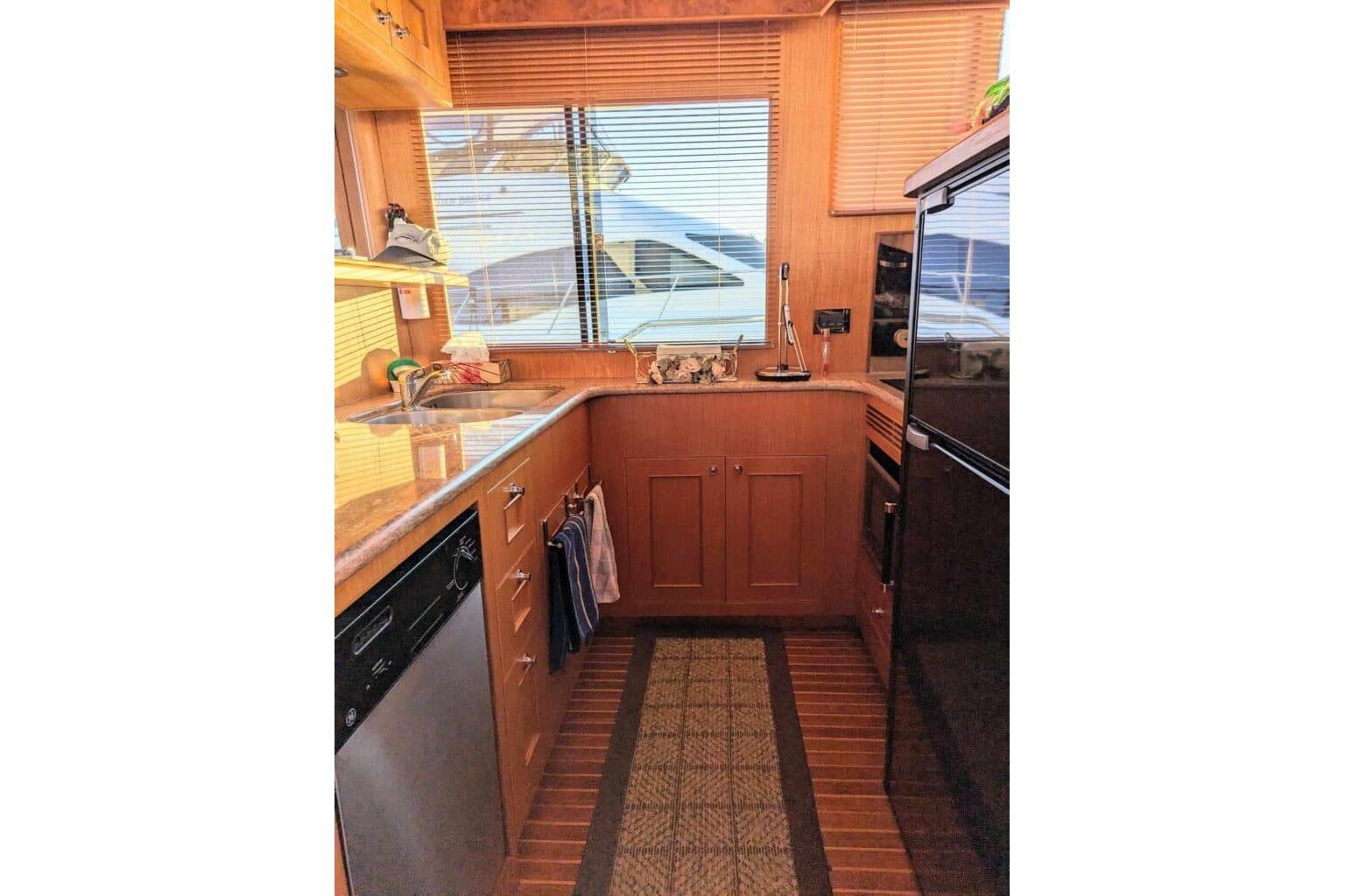 2008 Ocean Alexander 48C Classicco yacht kitchen with wood cabinetry and modern appliances.