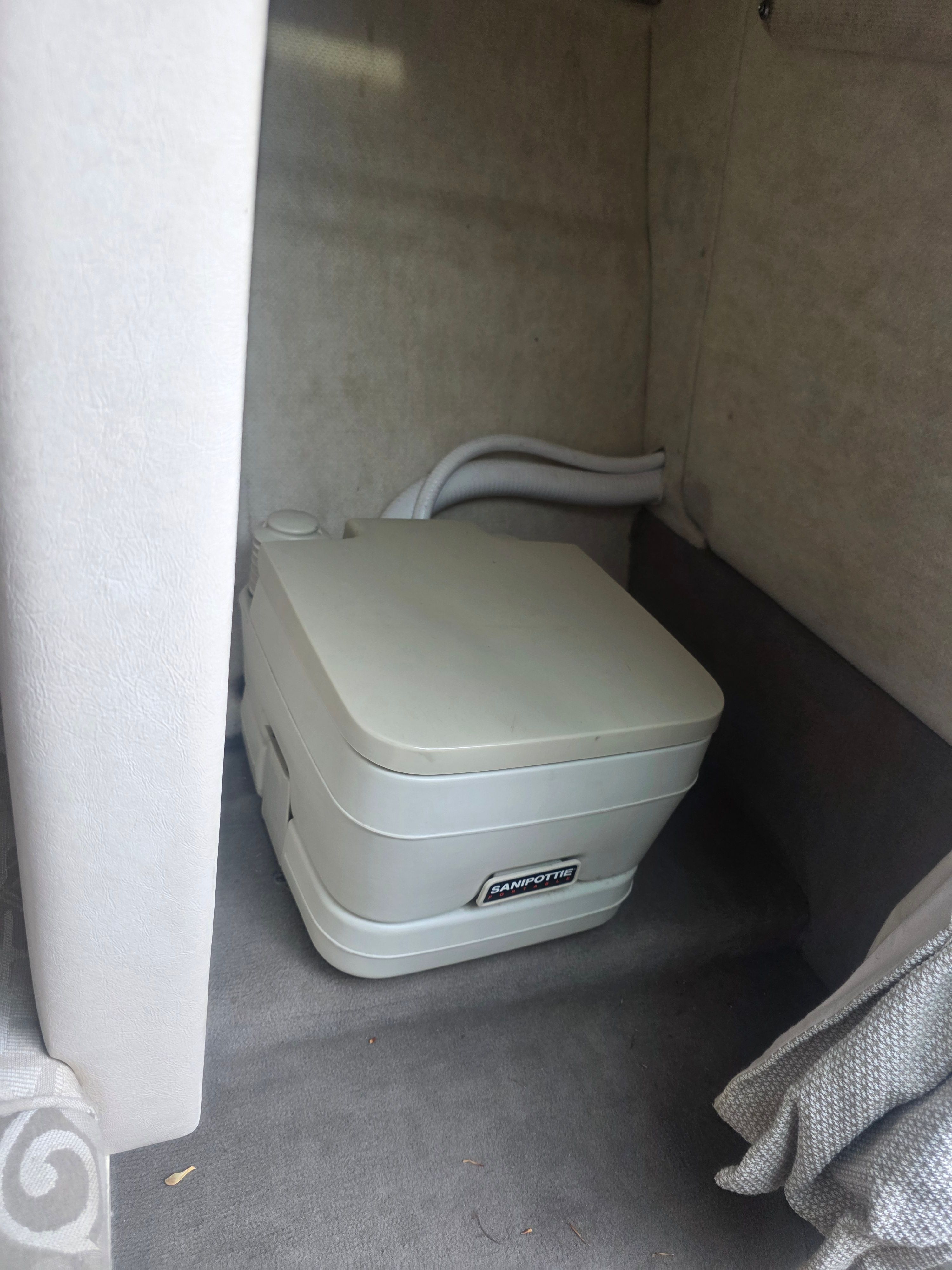Portable toilet in a 2004 Sea Ray 225 Weekender.