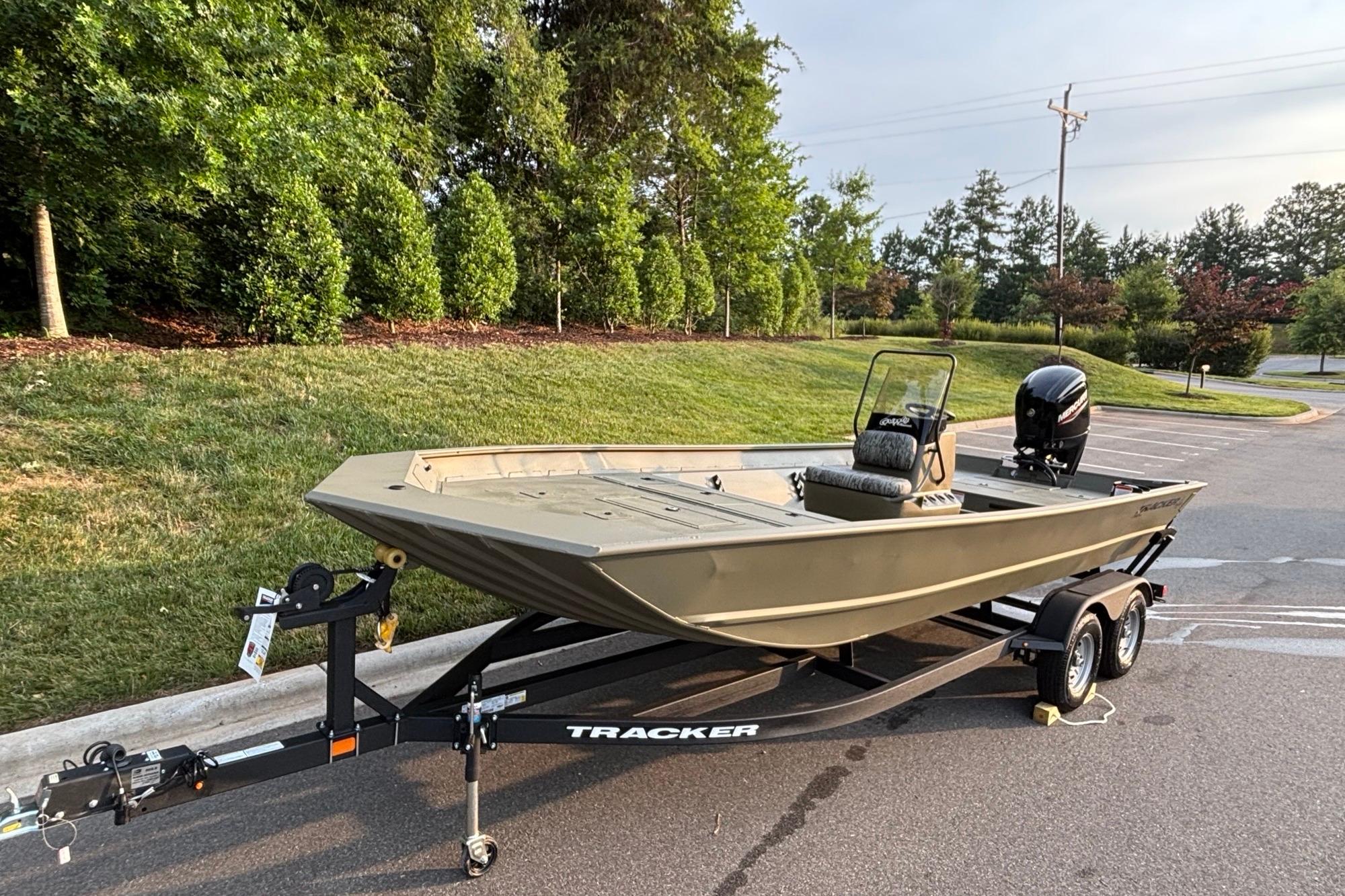 2026 Tracker Grizzly 2072 CC boat on trailer in a parking lot.
