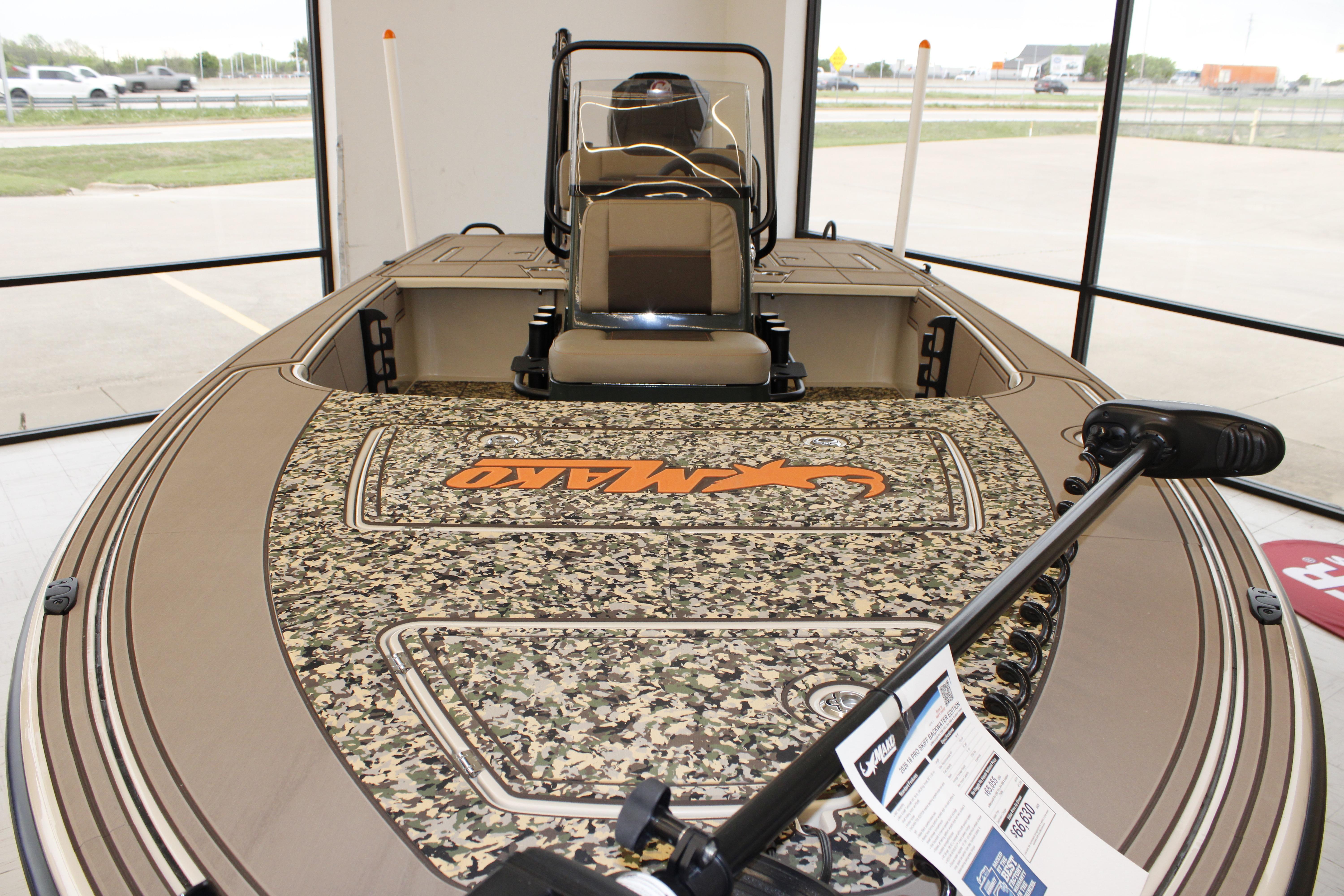 2026 Mako 18 Pro Skiff Backwater Edition with camouflage deck in showroom.