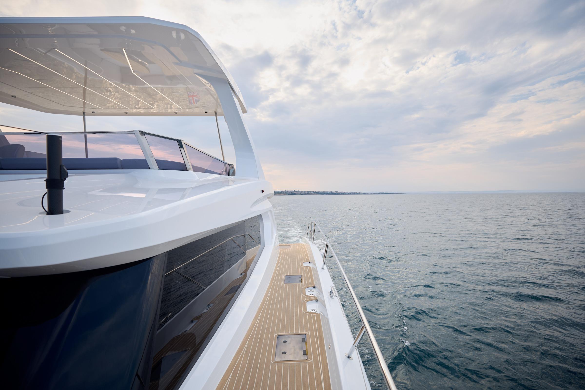2025 Omaya 50 Power Catamaran cruising on open sea under cloudy sky.
