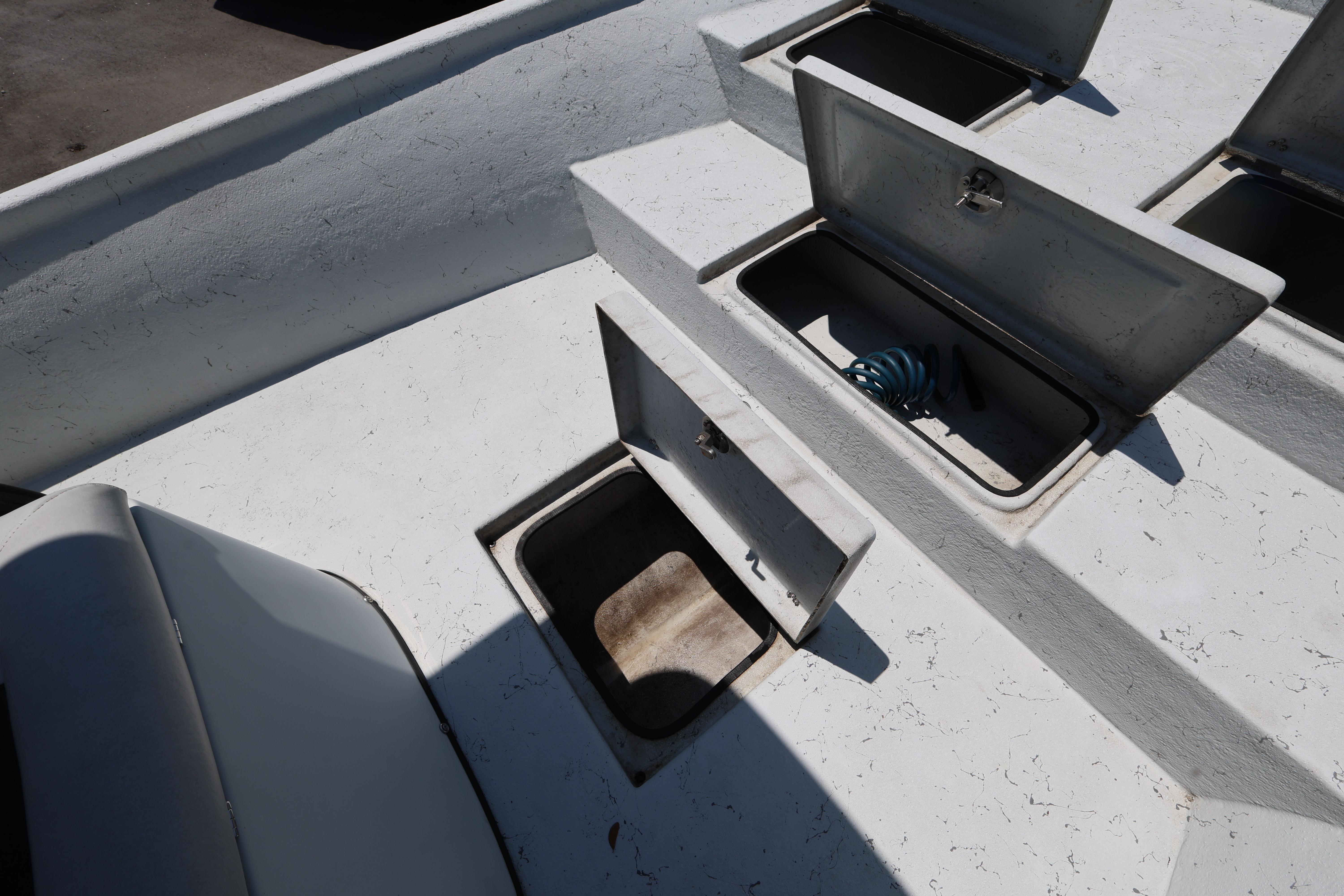 Open storage compartments on a 2021 Blazer Bay 2400 boat deck.