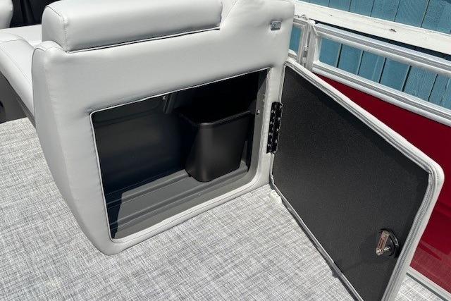 2026 Sun Tracker SportFish 20 DLX boat storage compartment with open door and interior view.