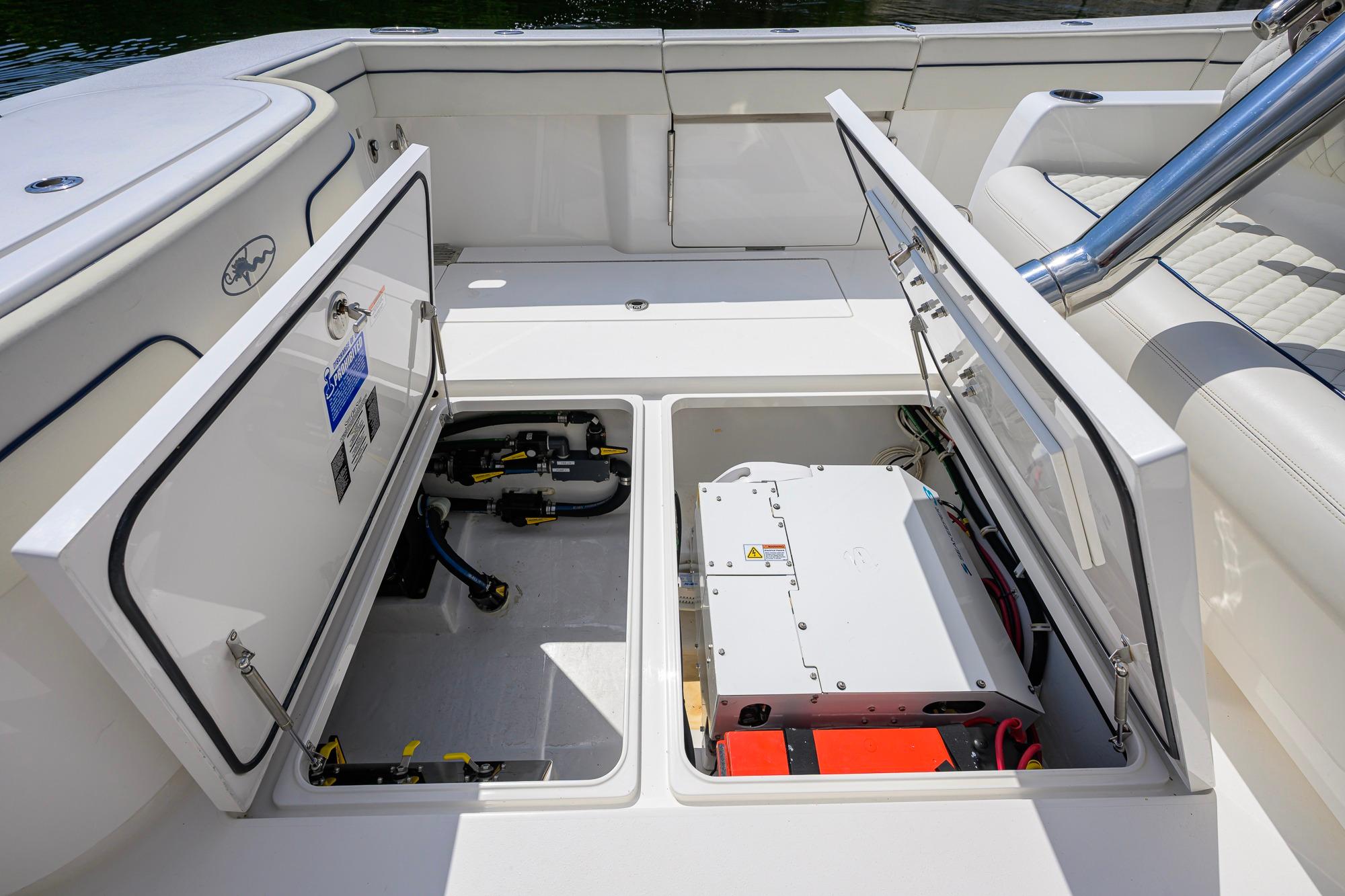 2020 Valhalla Boatworks V-41 storage compartments open, showcasing interior equipment and wiring.
