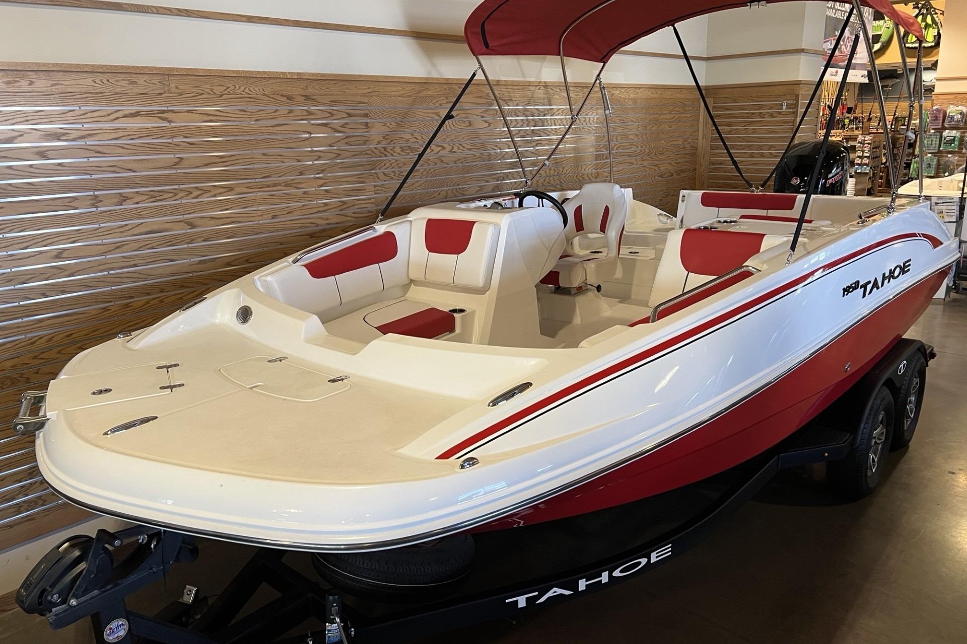 2025 Tahoe 1950 boat with red and white design, displayed indoors.