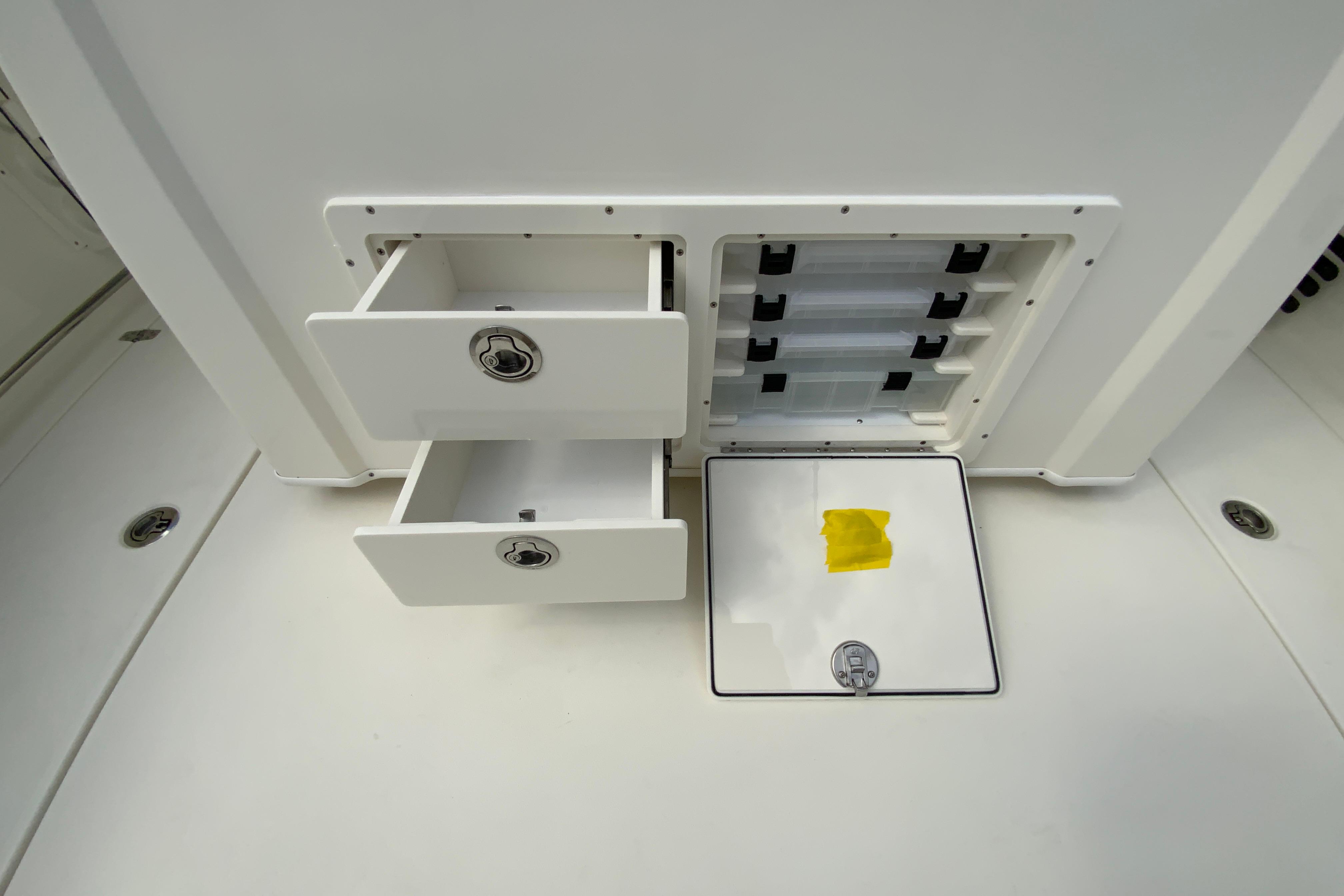 Storage compartments on a 2027 Cobia 320 Center Console boat.