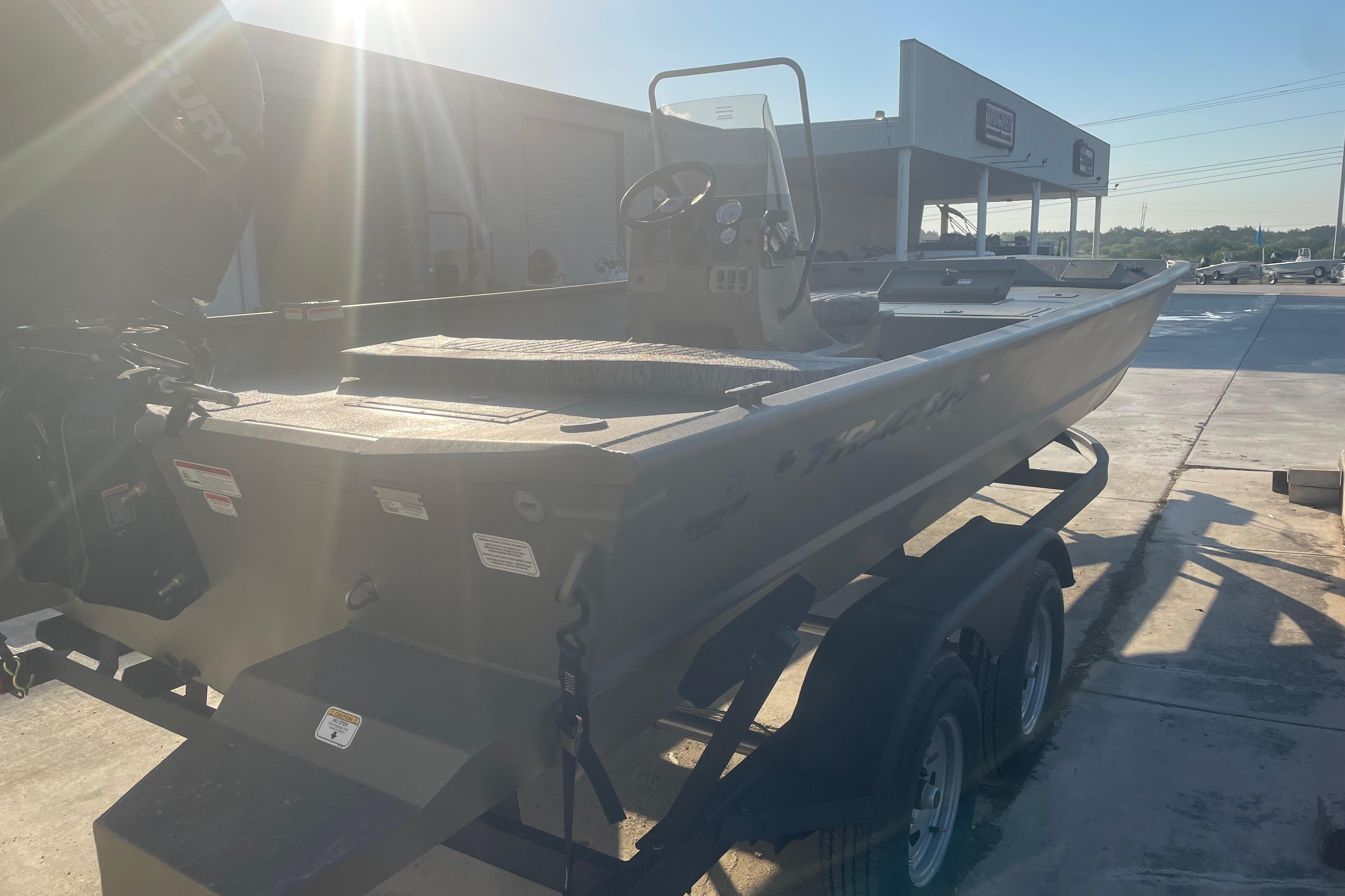 2026 Tracker Grizzly 2072 CC boat on trailer in sunny outdoor setting.