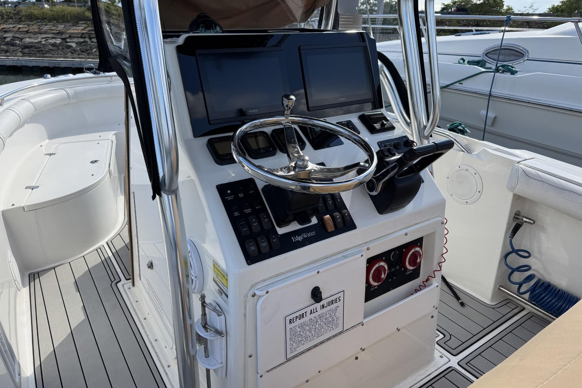 2007 Edgewater 245CC boat cockpit with steering wheel and control panel.