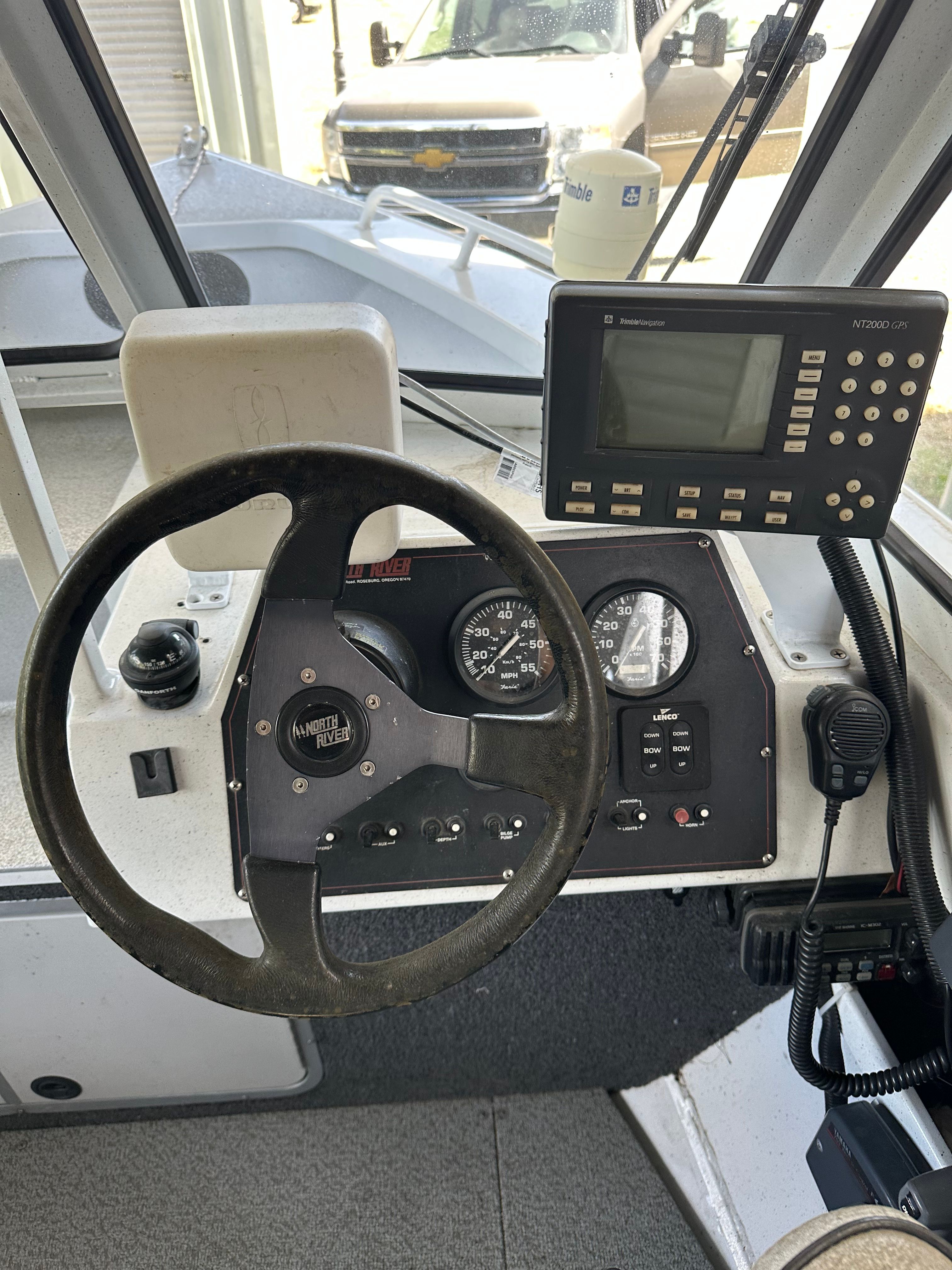 Helm of a 2006 North River Aluminum boat with steering wheel and instruments.