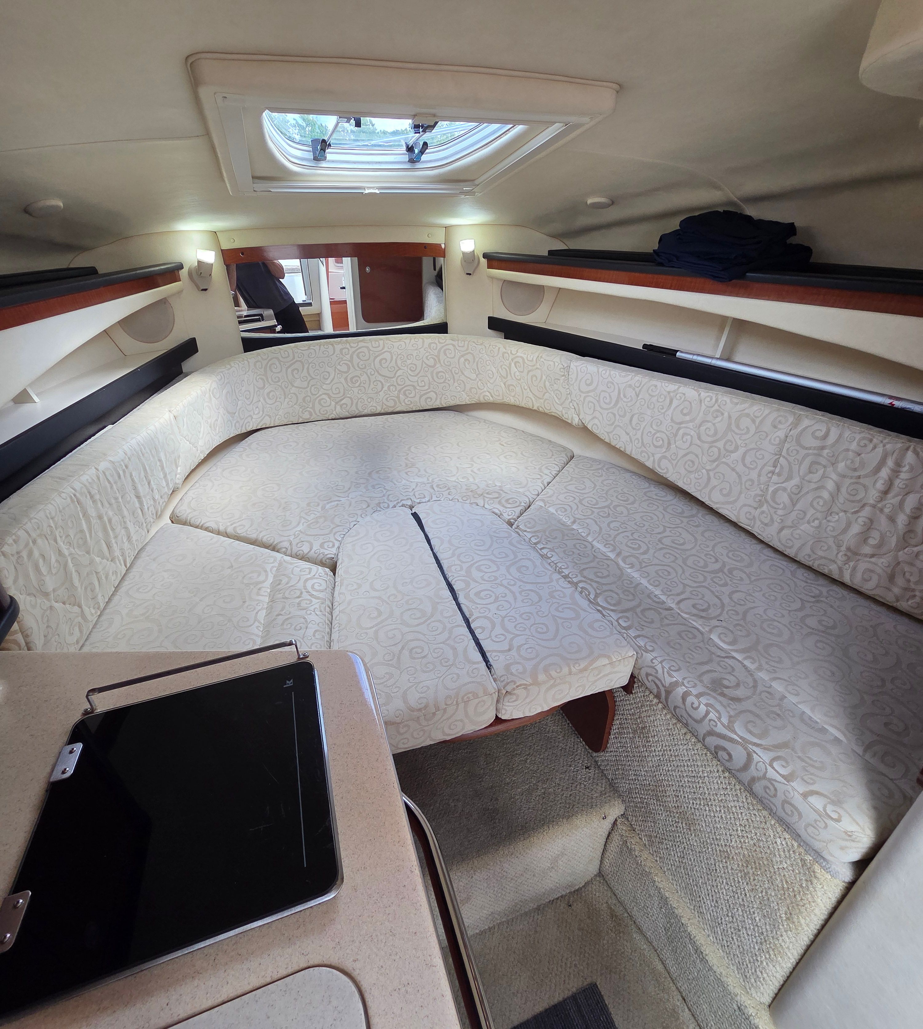 Interior of a 2005 Sea Ray Sundancer 260 with cushioned seating and skylights.